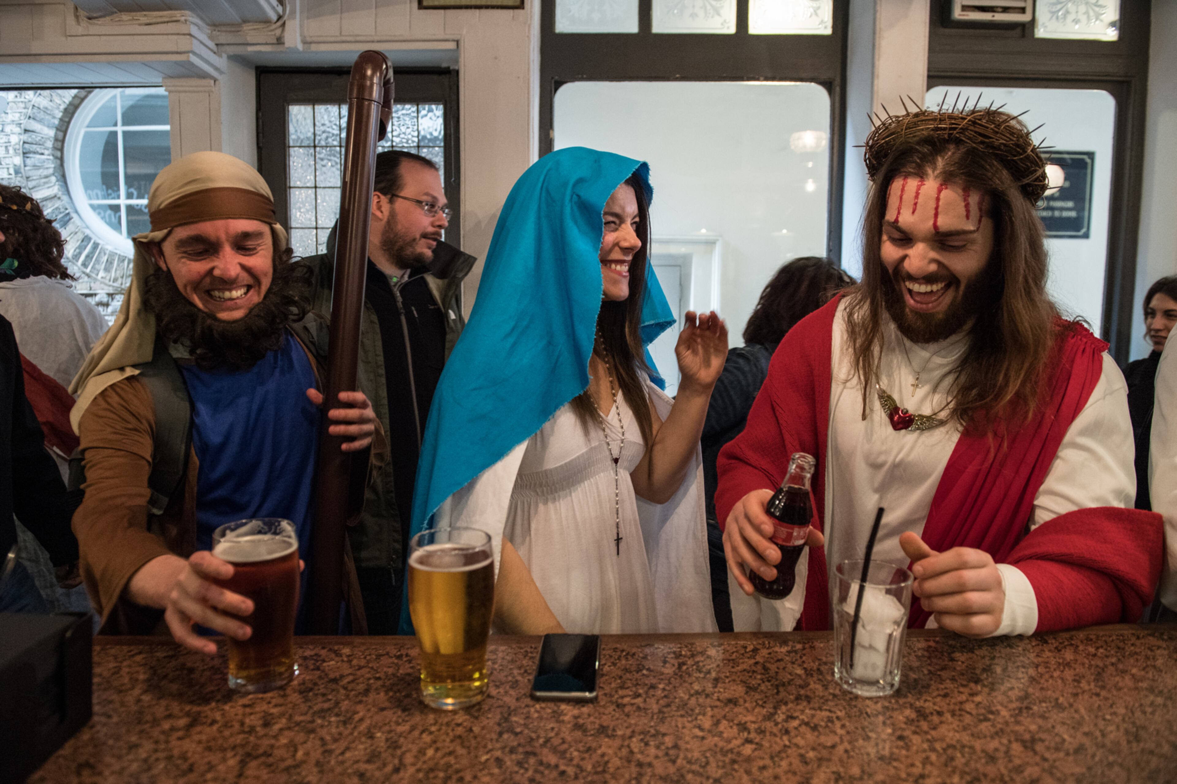 LONDON, ENGLAND - APRIL 16: Luigi Pertrilli (R) shares a joke with a woman dressed like the Virgin Mary in the Christopher Inn during the Christathon X pub crawl on April 16, 2017 in London, England. The Christathon pub crawl is celebrating its tenth year this year and sees participants dress as Jesus and visit pubs on Easter Sunday around the British capital whilst donating collections from those involved to the charity Save the Children. (Photo by Chris J Ratcliffe/Getty Images) *** BESTPIX ***