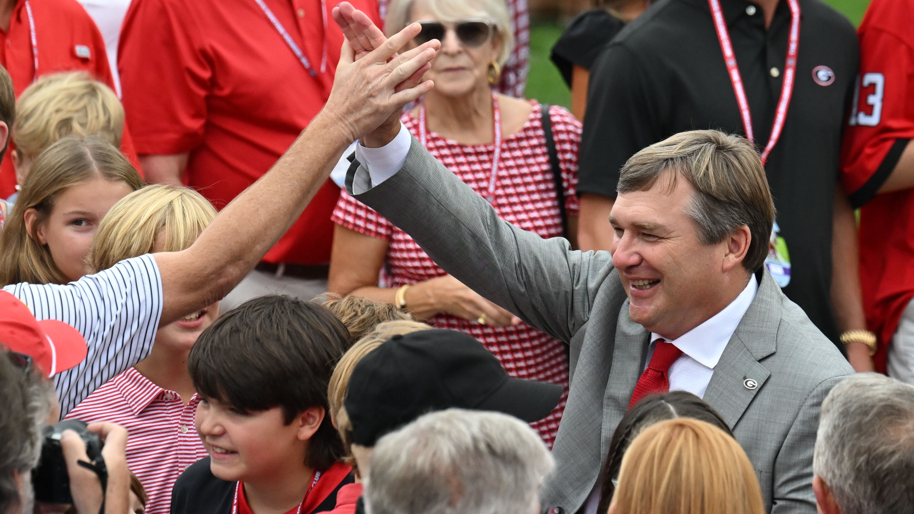 Georgia's head coach Kirby Smart is surrounded by fans as players and coaching staff participate in the Dawg Walk before their game against South Carolina in an NCAA football game at Sanford Stadium, Saturday, September 16, 2023, in Athens. (Hyosub Shin / Hyosub.Shin@ajc.com)