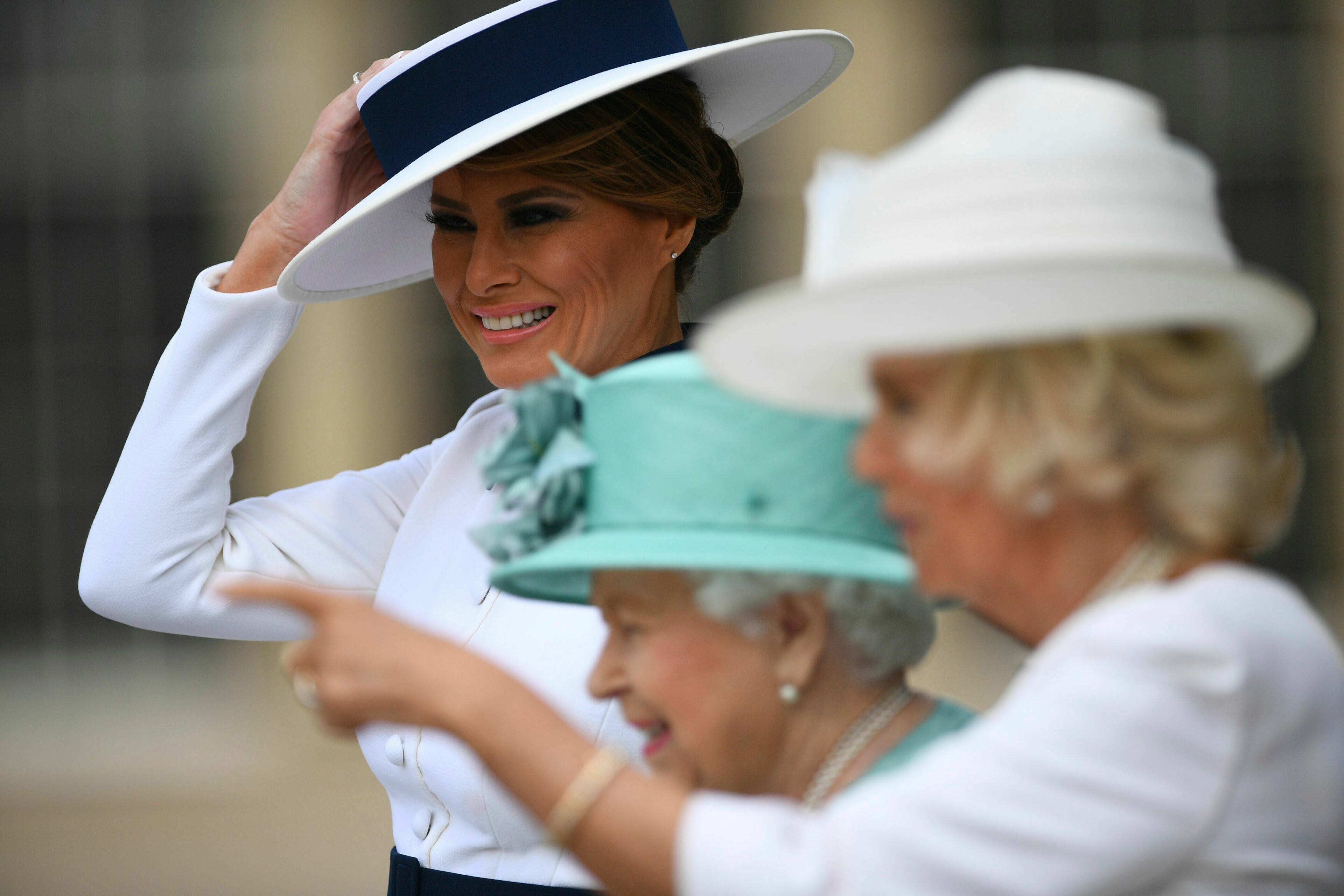 US First Lady Melania Trump, left, attends a welcome ceremony with Britain's Queen Elizabeth and Camilla, Duchess of Cornwall, right, in the garden of Buckingham Palace, in London, Monday, June 3, 2019, on the first day of a three day state visit to Britain. (Victoria Jones/Pool via AP)