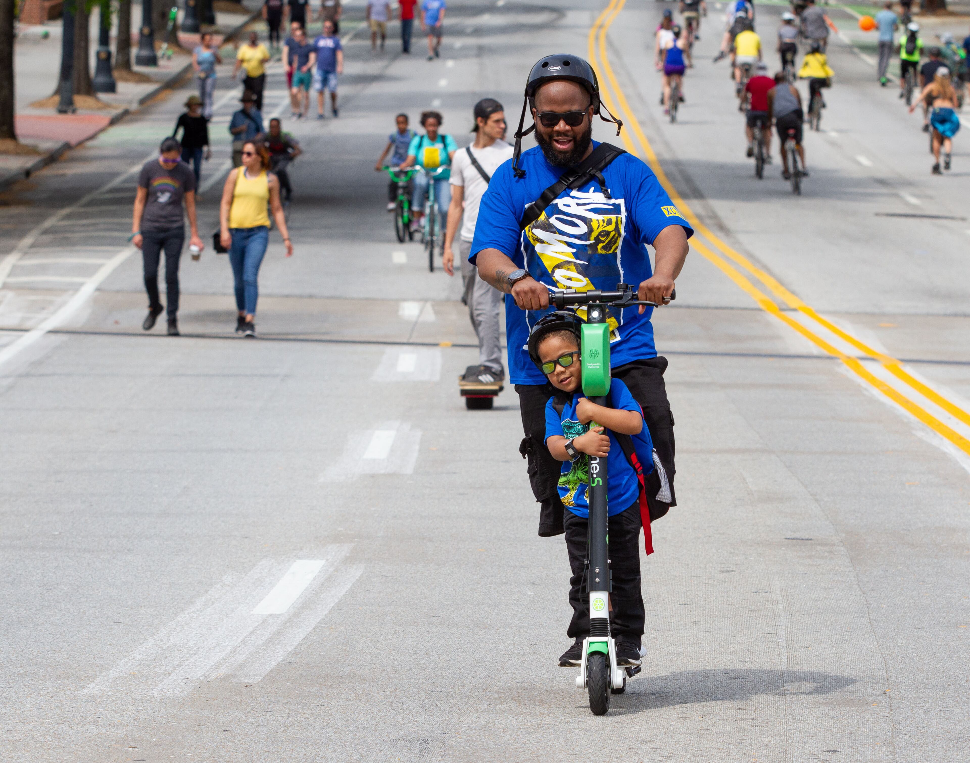 Corey Wills and his son C.J. make their way down Peachtree Street during the Atlanta Streets Alive ride on Sunday, April 7, 2019. The Atlanta Bicycle Coalition activated 3.1 miles of Peachtree Street for the Sunday afternoon ride. STEVE SCHAEFER / SPECIAL TO THE AJC