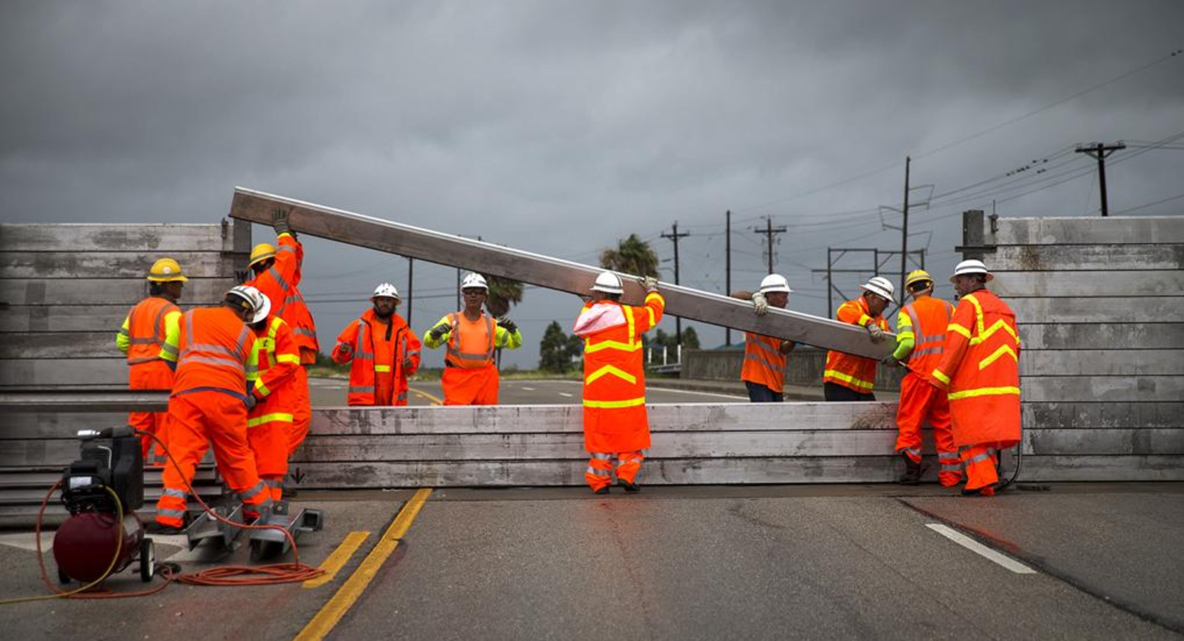 TxDOT crews install the final portion of a surge wall on TX-361 leading to the Port Aransas ferry in Aransas Pass, Texas, on Friday, August 25, 2017. Hurricane Harvey is expected to make landfall on the Texas coast tonight or early Saturday morning as a category 3 hurricane.