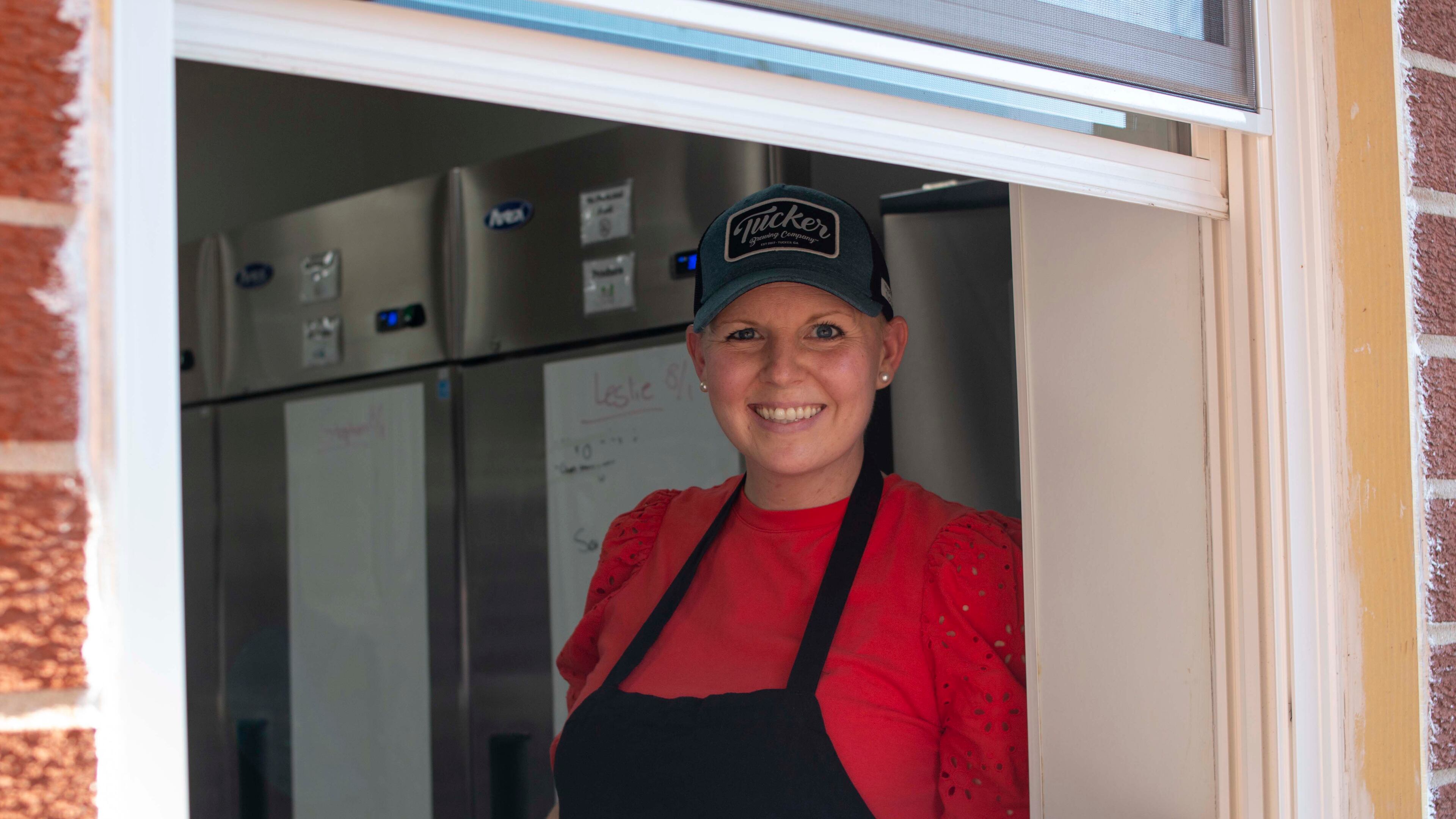 CEO and co-owner Ashley Chapman Hubbard, shown in the Tucker Brewing kitchen window on opening night, had long dreamed of adding an on-site kitchen.
Contributed by Eliana Barnard, Tucker Brewing Co.