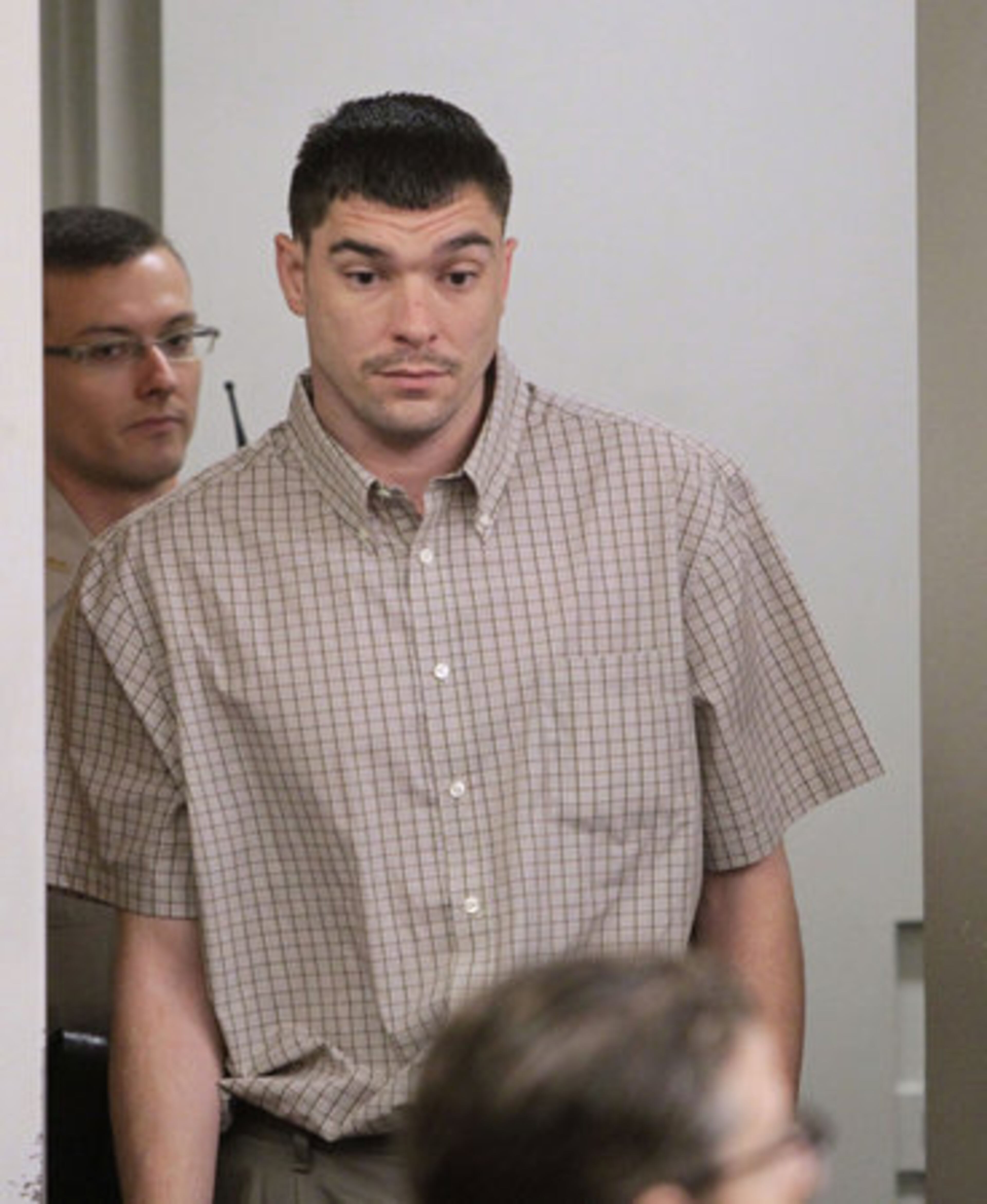 Phillip Dunn enters court on Thursday to testify in his defense. He is charged with the Feb. 14, 2010, slaying of his wife in a Suwanee Walmart parking lot.