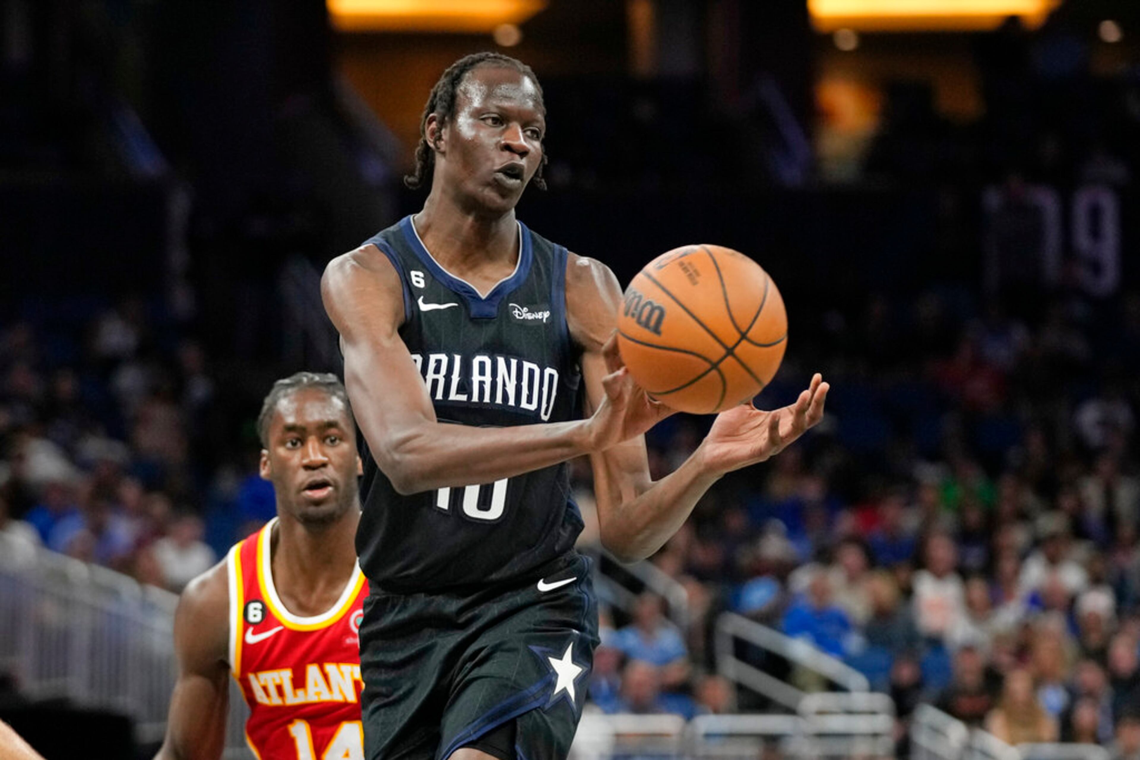 Orlando Magic's Bol Bol right, passes the ball as Atlanta Hawks' AJ Griffin, left, defends during the second half of an NBA basketball game, Wednesday, Dec. 14, 2022, in Orlando, Fla. (AP Photo/John Raoux)