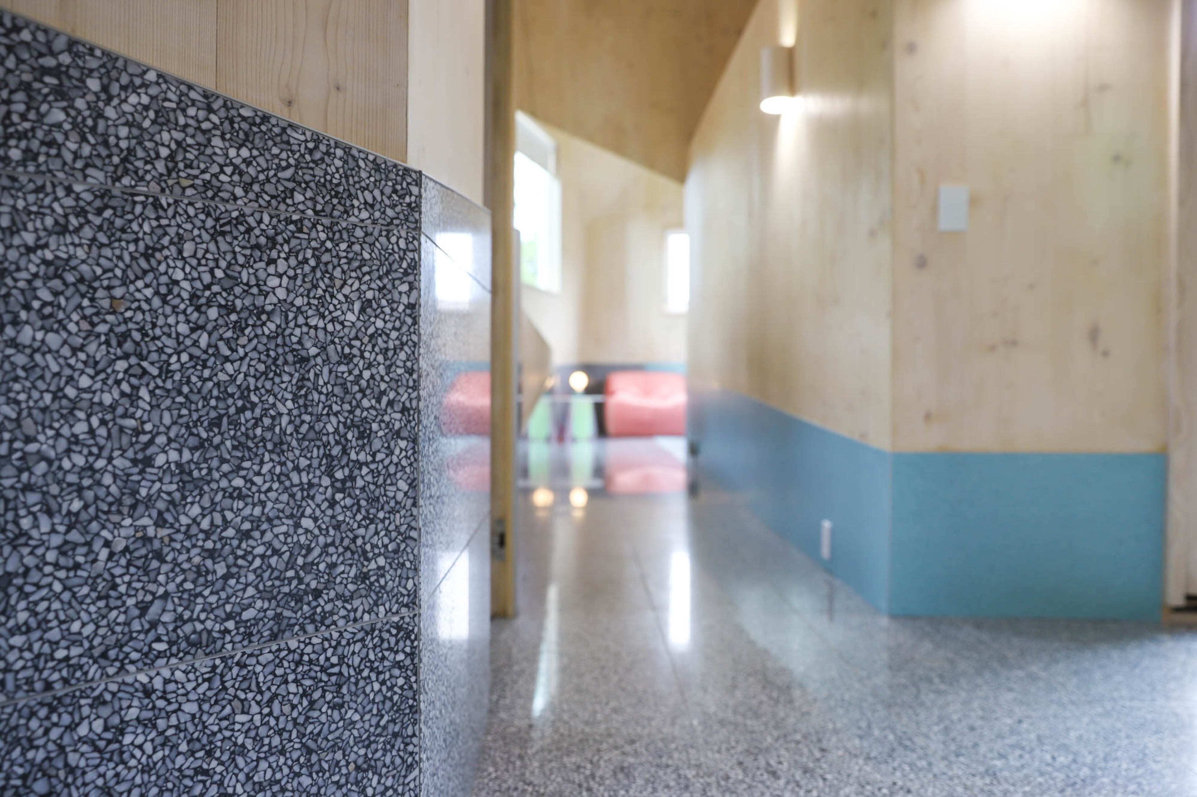 Terrazzo tile by Eco-Terr in Silverado Black lines the catwalk. "There will always be people that want traditional homes but I really think there's a larger appetite for contemporary work," said homeowner Jennifer Bonner, an associate professor of architecture at Harvard Graduate School of Design.