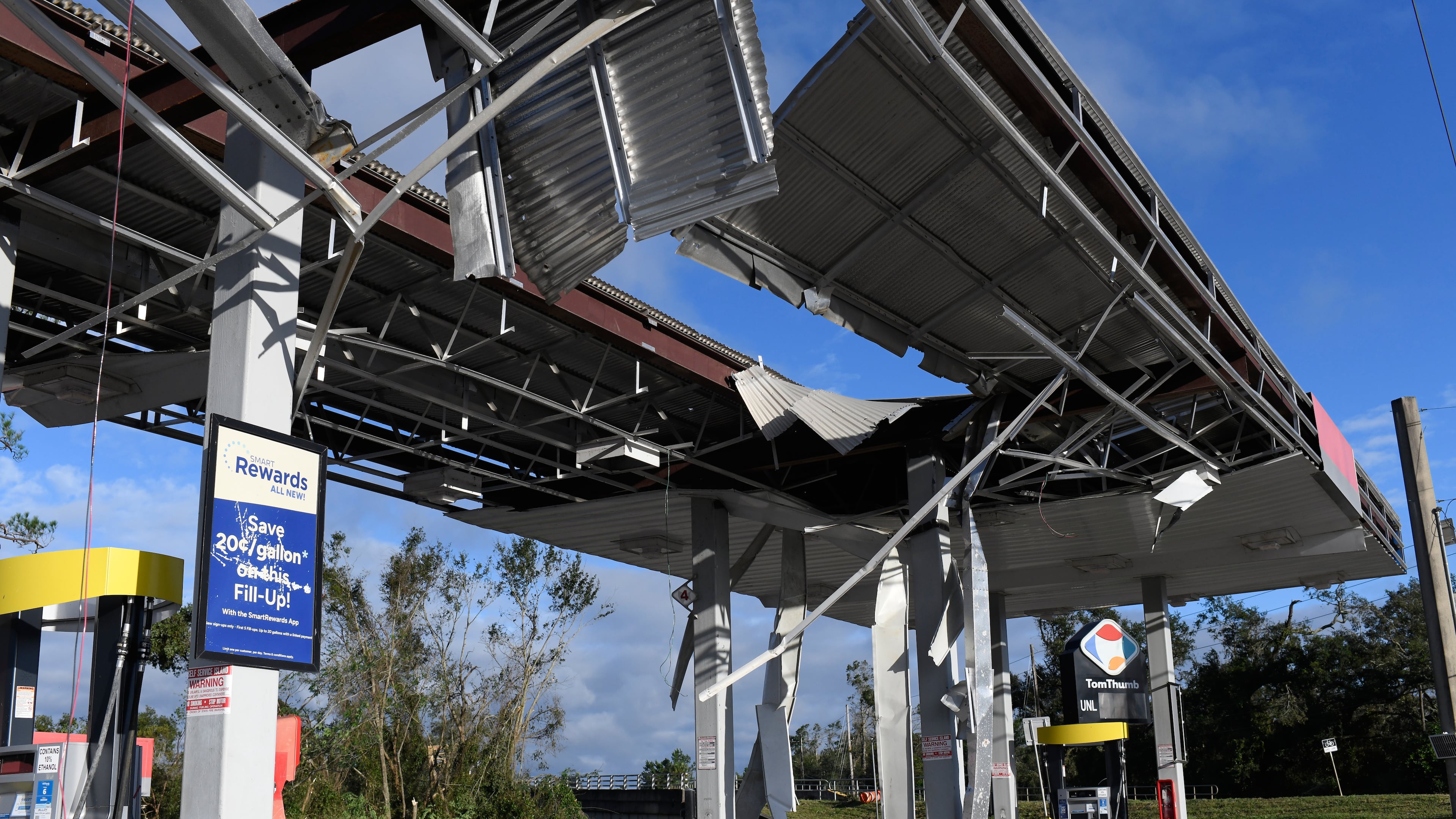 A gas station is damaged by the effects of Isaias on Saturday, Oct. 10, 2026, in East Milton, Fla. (AP Photo/Octavio Jones)