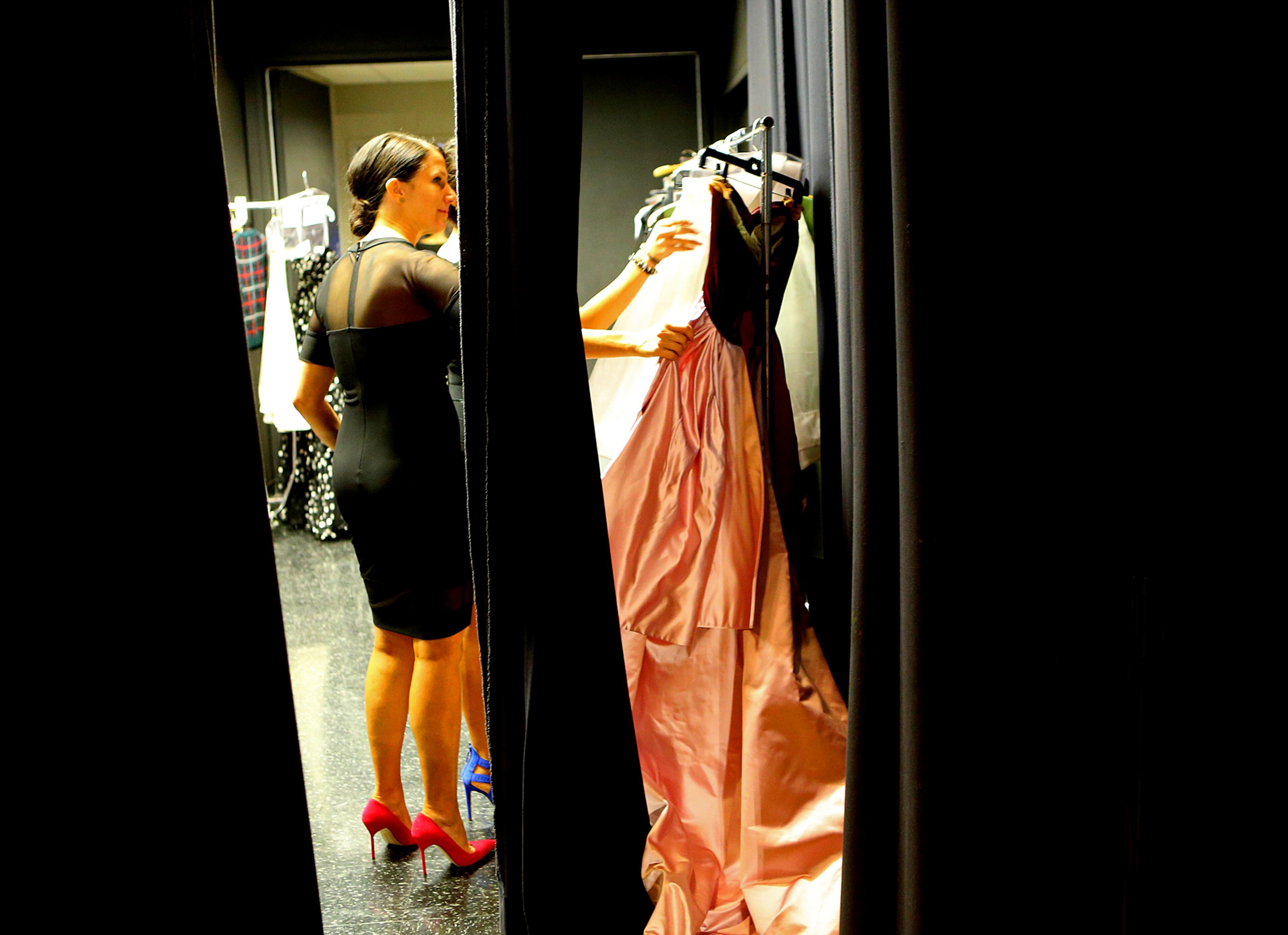Dresses are prepared for models backstage during the Jeffrey Cares Fashion Show Monday, Aug. 25, 2014, in Atlanta. The show raises awareness and funds for its beneficiaries the Susan G. Komen for the Cure Greater Atlanta Affiliate and the Atlanta AIDS Fund. CURTIS COMPTON / CCOMPTON@AJC.COM