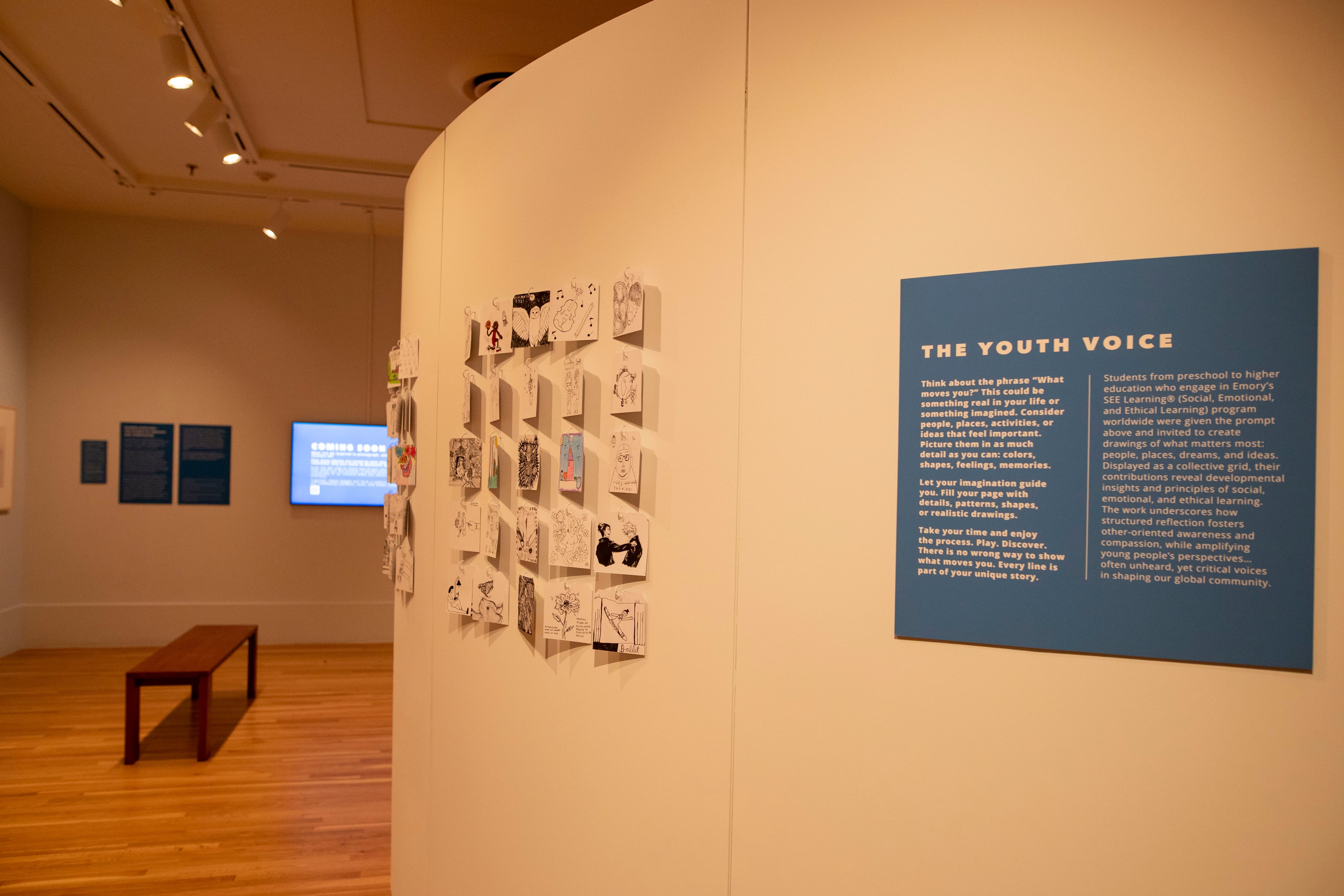 Student guests are encouraged to draw what moves them. "Fill your page with details, patterns, shapes or realistic drawings," they are prompted. "Every line is part of your unique story." Some of the drawings are displayed to the left of the wall text. (Isadora Pennington/Courtesy of ArtsATL)