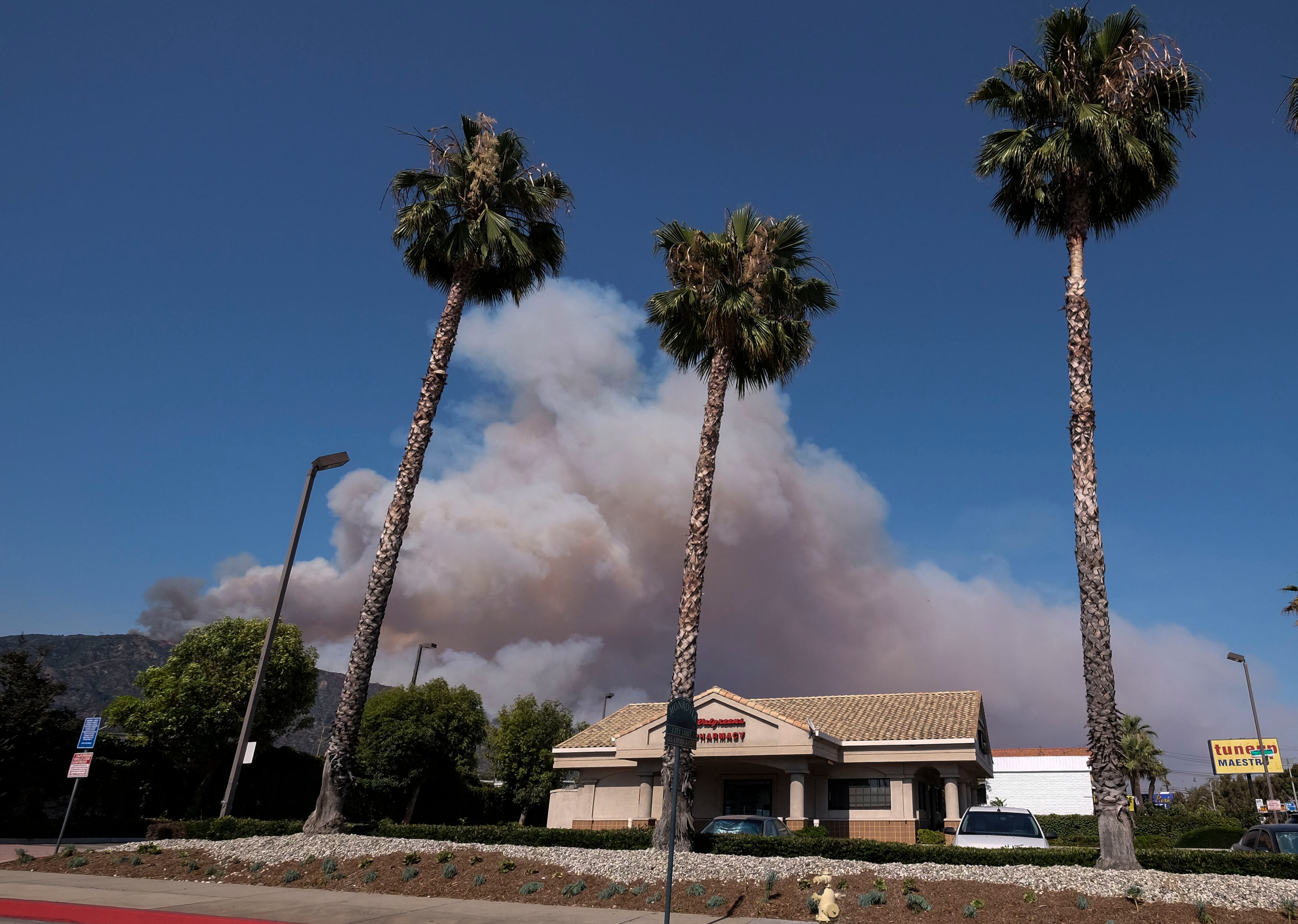 Smoke from wildfires burning in Angeles National Forest fills the sky on Monday, June 20, 2016. (AP Photo/Ringo H.W. Chiu)
