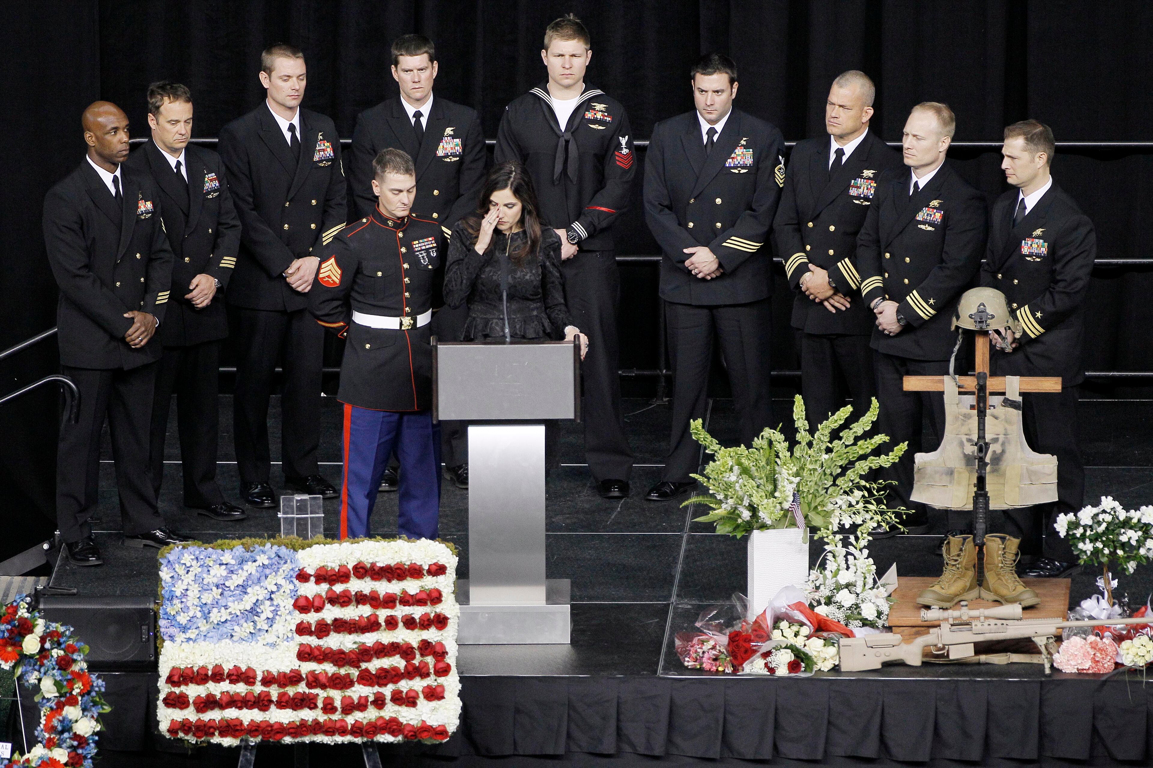 Christopher Kyle's wife, Taya, wipes tears away while memorializing her husband during a memorial service at Cowboys Stadium, Monday, Feb. 11, in Arlington, Texas. Thousands attended the public memorial service for Kyle, the former Navy SEAL sniper who was shot to death at a Texas shooting range.