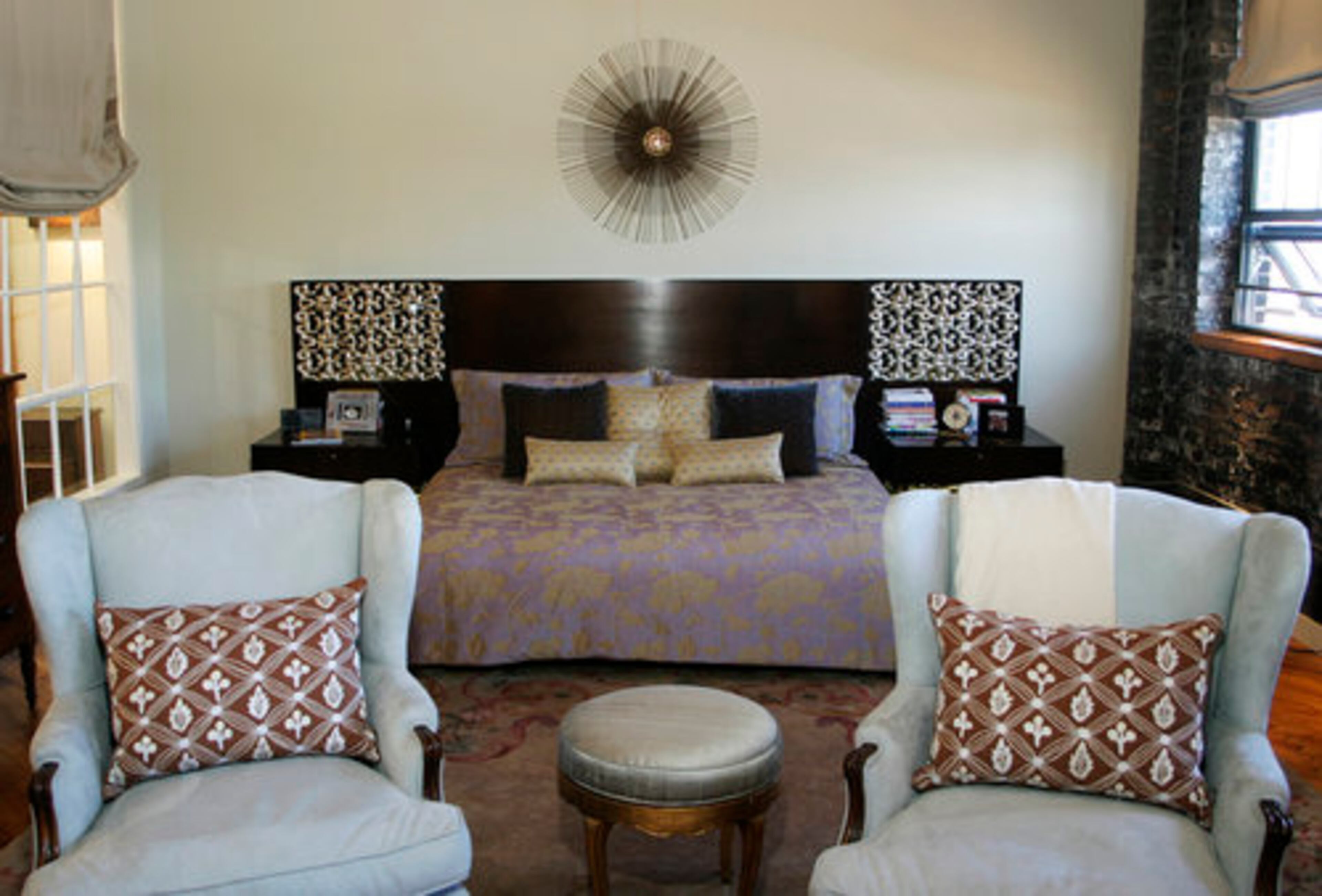 A pastel palette injects a peaceful feeling into the master bedroom. The original brick wall and flooring of the factory space remain.