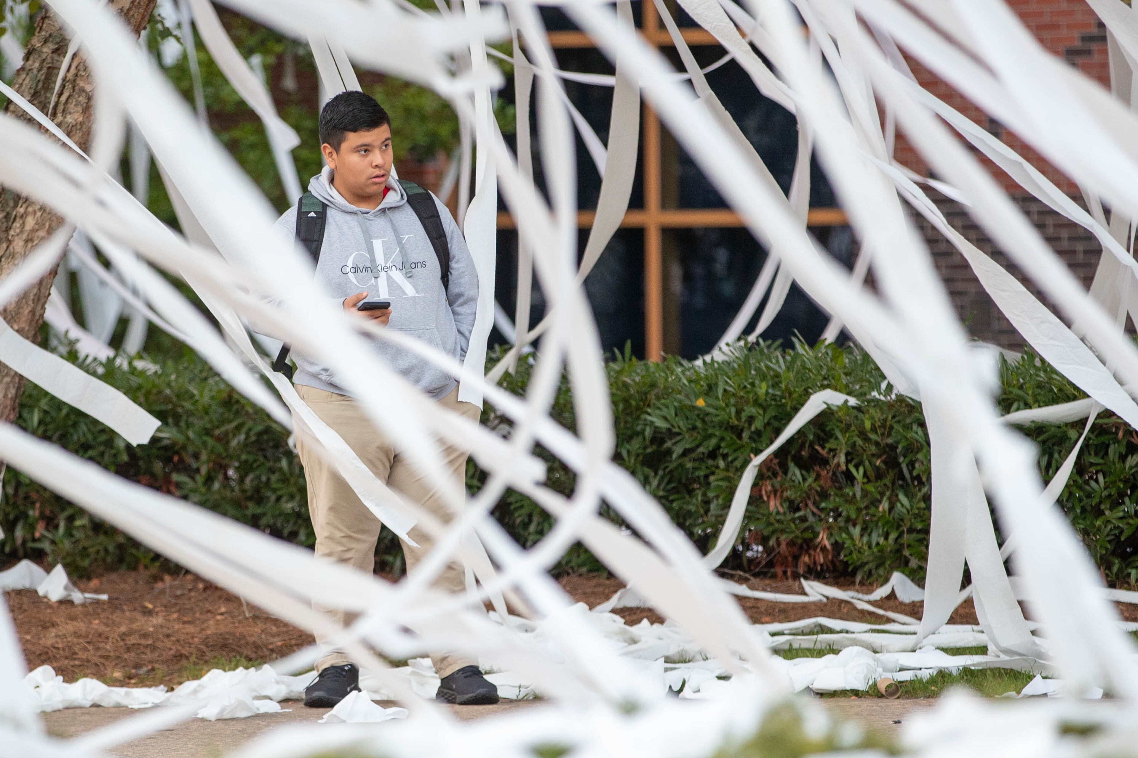 Student waits for doors to open on the first day in Marietta on Wednesday, August 2, 2023. Following with tradition, the new seniors of Marietta High School TPed their school the night before the first day. (Katelyn Myrick/katelyn.myrick@ajc.com)