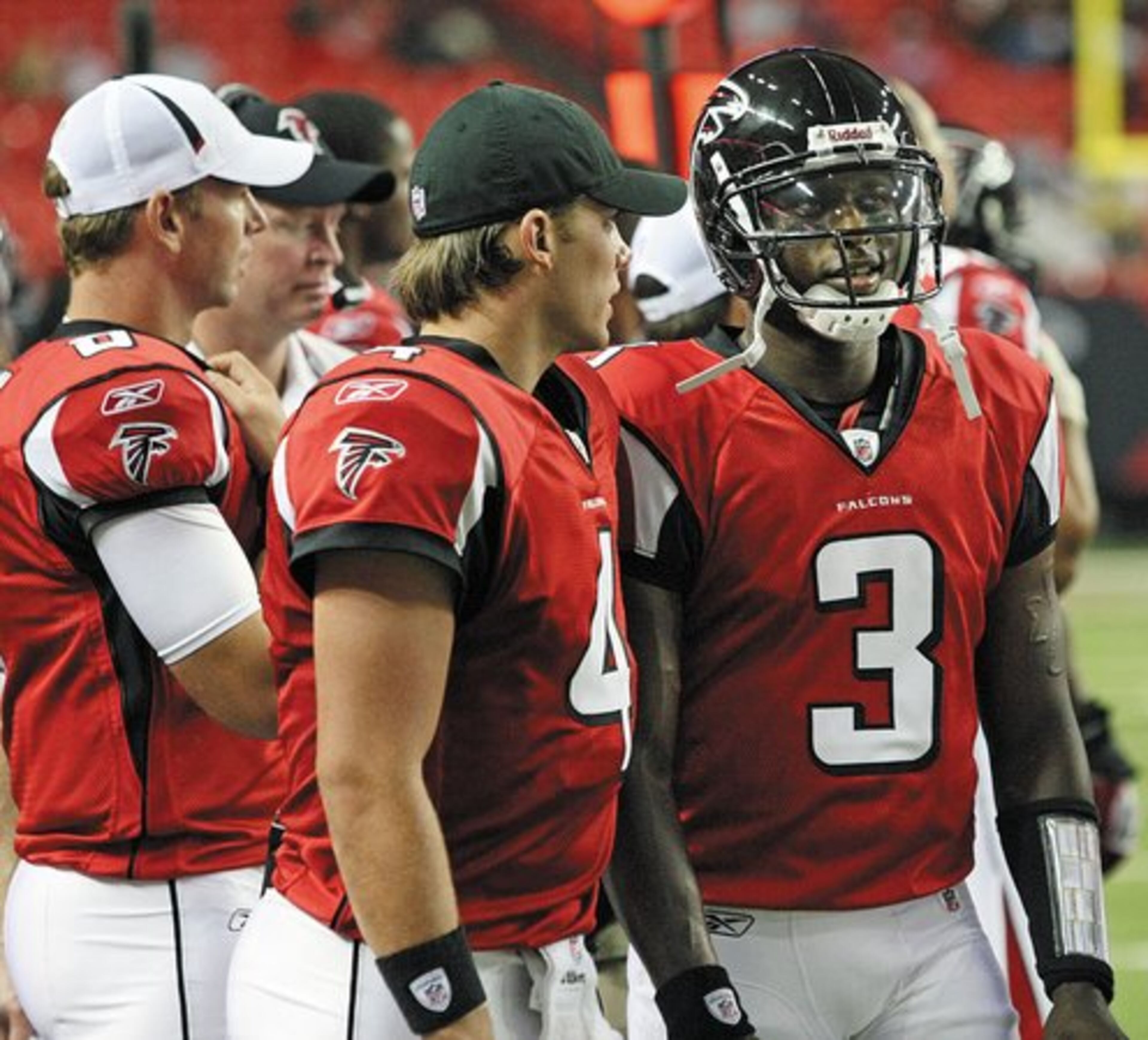 Falcons quarterback John Parker Wilson talks to quarterback D.J. Shockley on the sidelines.