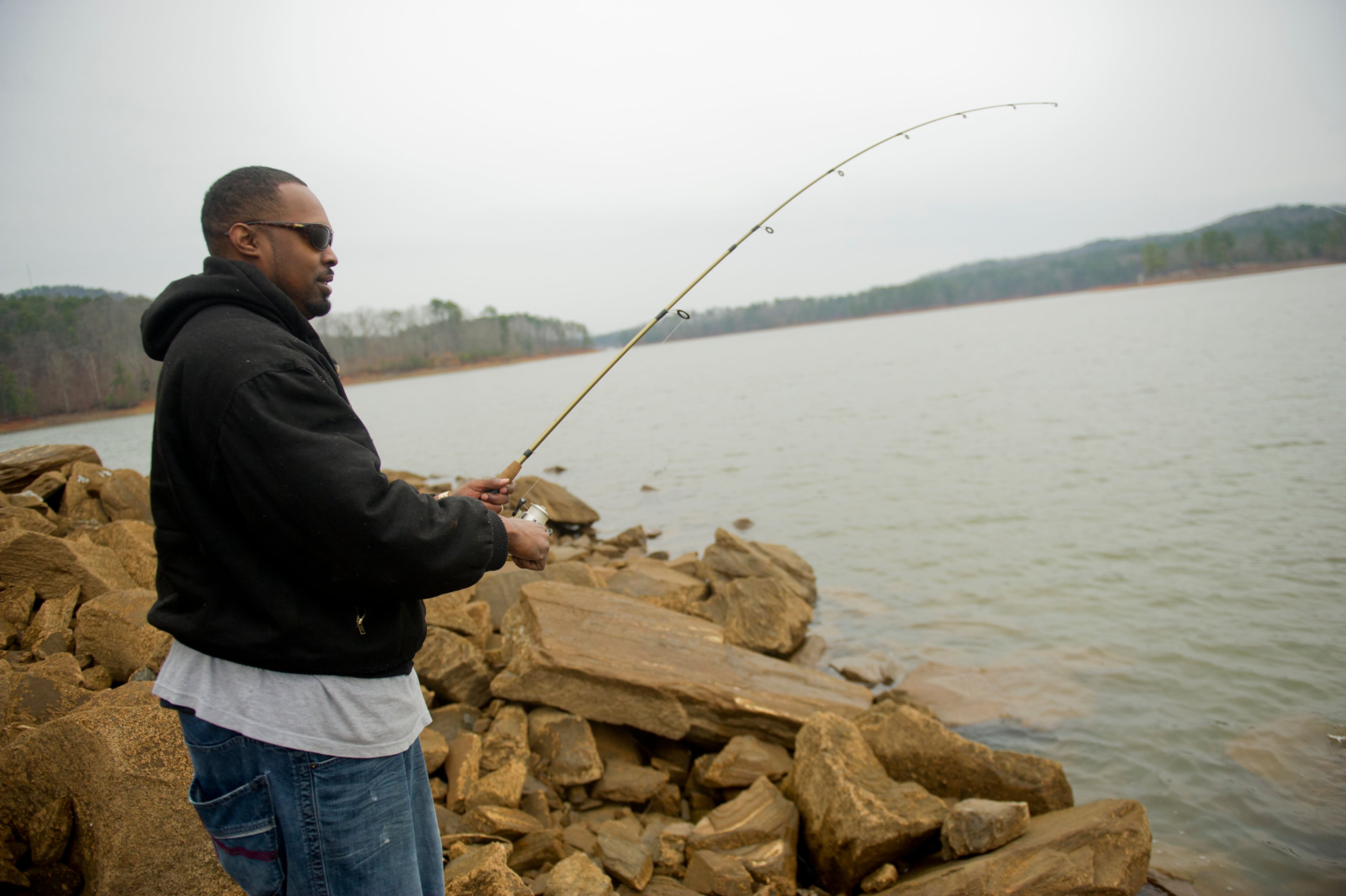 Joe Fountain braves the rainy weather as he fishes at Lake Allatoona in Cartersville on Saturday, December 28, 2013.