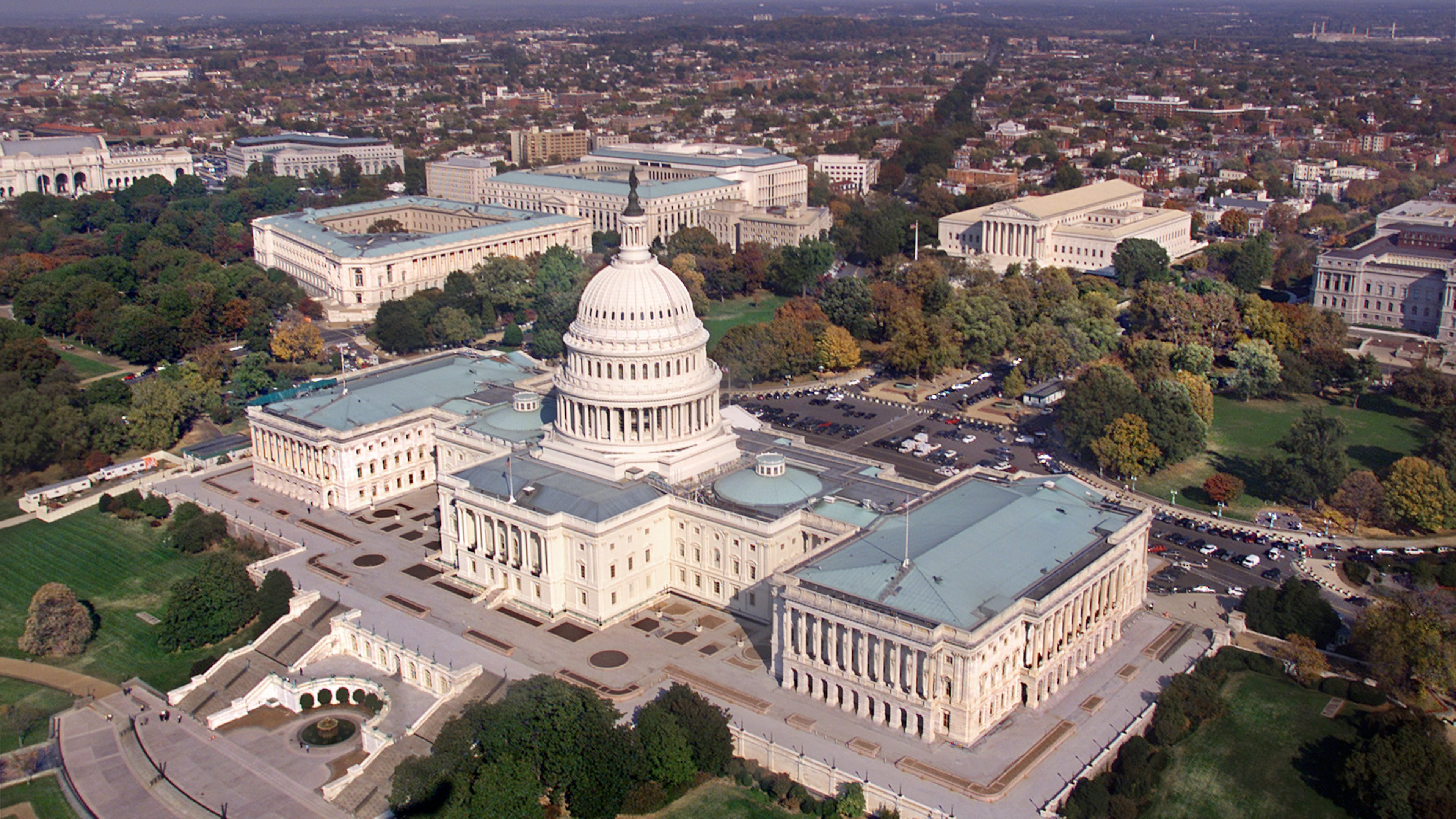 An aerial view of the U.S. Capitol, with the Senate to the left of the dome and the House of Representatives at the right. The three Senate office buildings, Russell, Dirksen, and Hart, left to right, are seen in a cluster beyond the top of the dome. AP/J. Scott Applewhite
