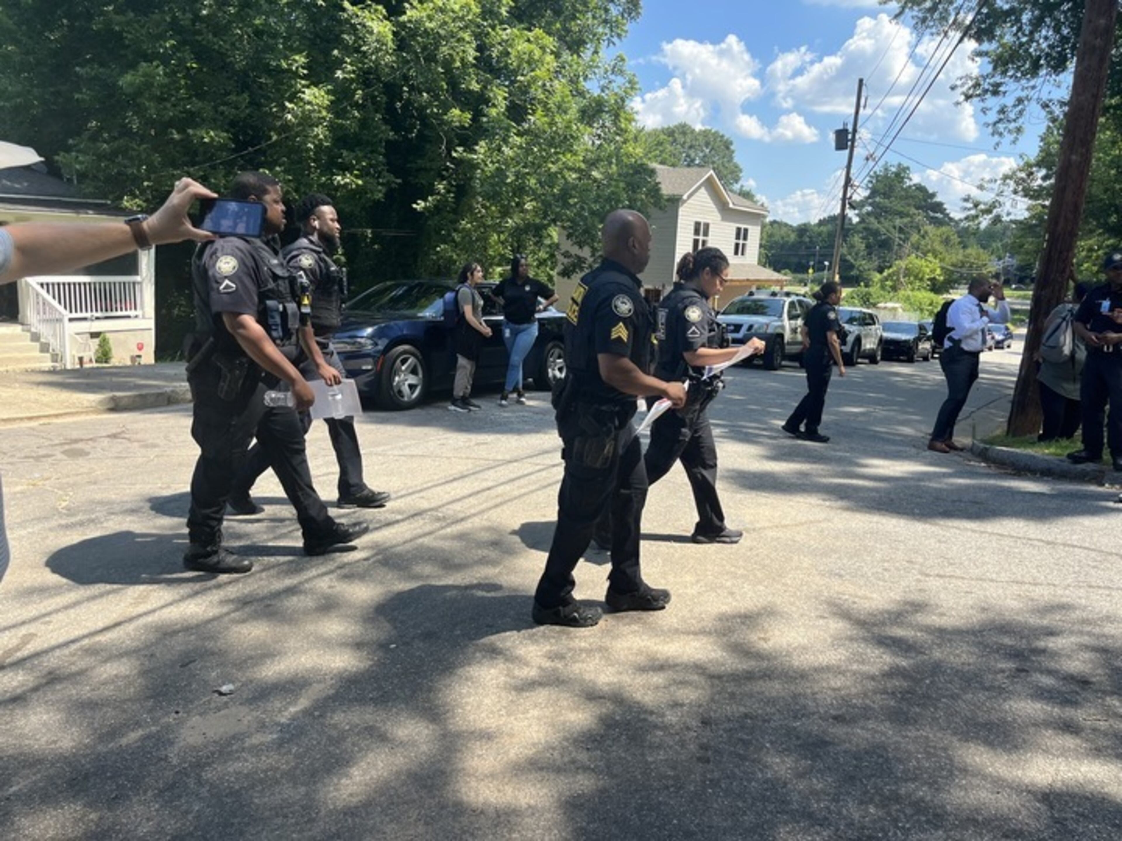 Police officers spoke to locals in the area of Sparks Street in southwest Atlanta on Friday about the fatal shooting of two teenagers that happened July 2. Officials canvassed the neighborhood to raise awareness and try to learn information that could aid in the homicide investigation.