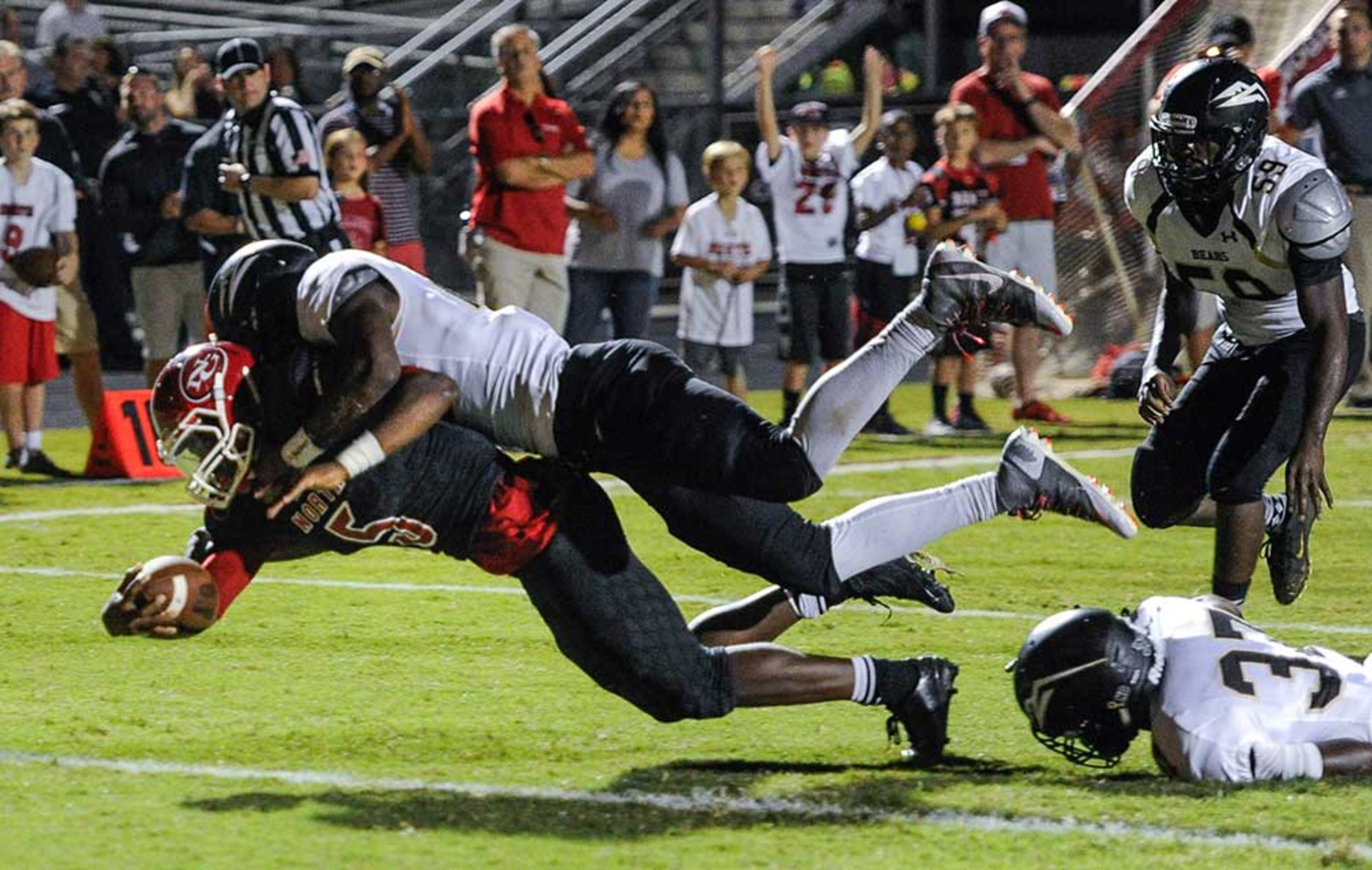 North Gwinnett RB Tyler Goodson dives for a touchdown as Mountain View LB Jeremiah Noble tries to stop him with a tackle during the first half of Friday's game.
