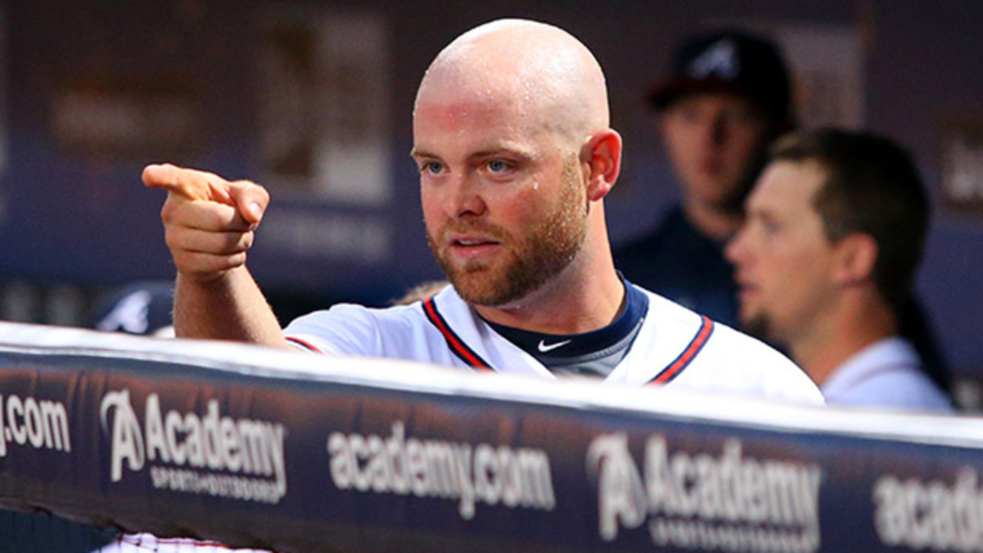 092513 Atlanta: Angry Braves catcher Brian McCann points from the dugout at the Brewers dugout after his confrontaton with Brewers batter Carlos Gomez for show boating resulted in both benches clearing during the first inning on Wednesday, Sept. 25, 2013, in Atlanta. CURTIS COMPTON /staff CCOMPTON@AJC.COM