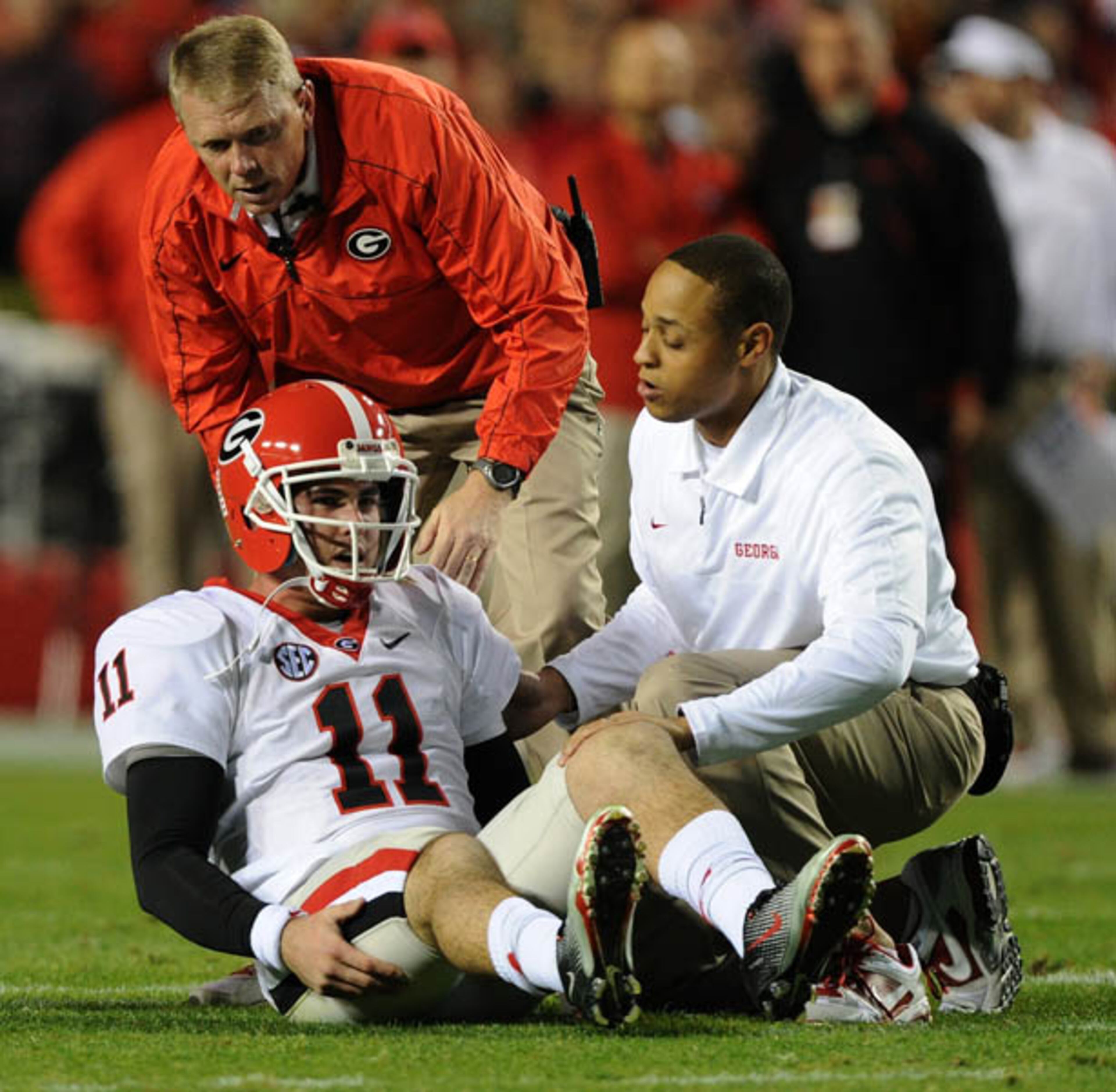 Georgia's Aaron Murray receives some aid from trainers after being hurt on a play. Murray sat out one play and returned to the game.