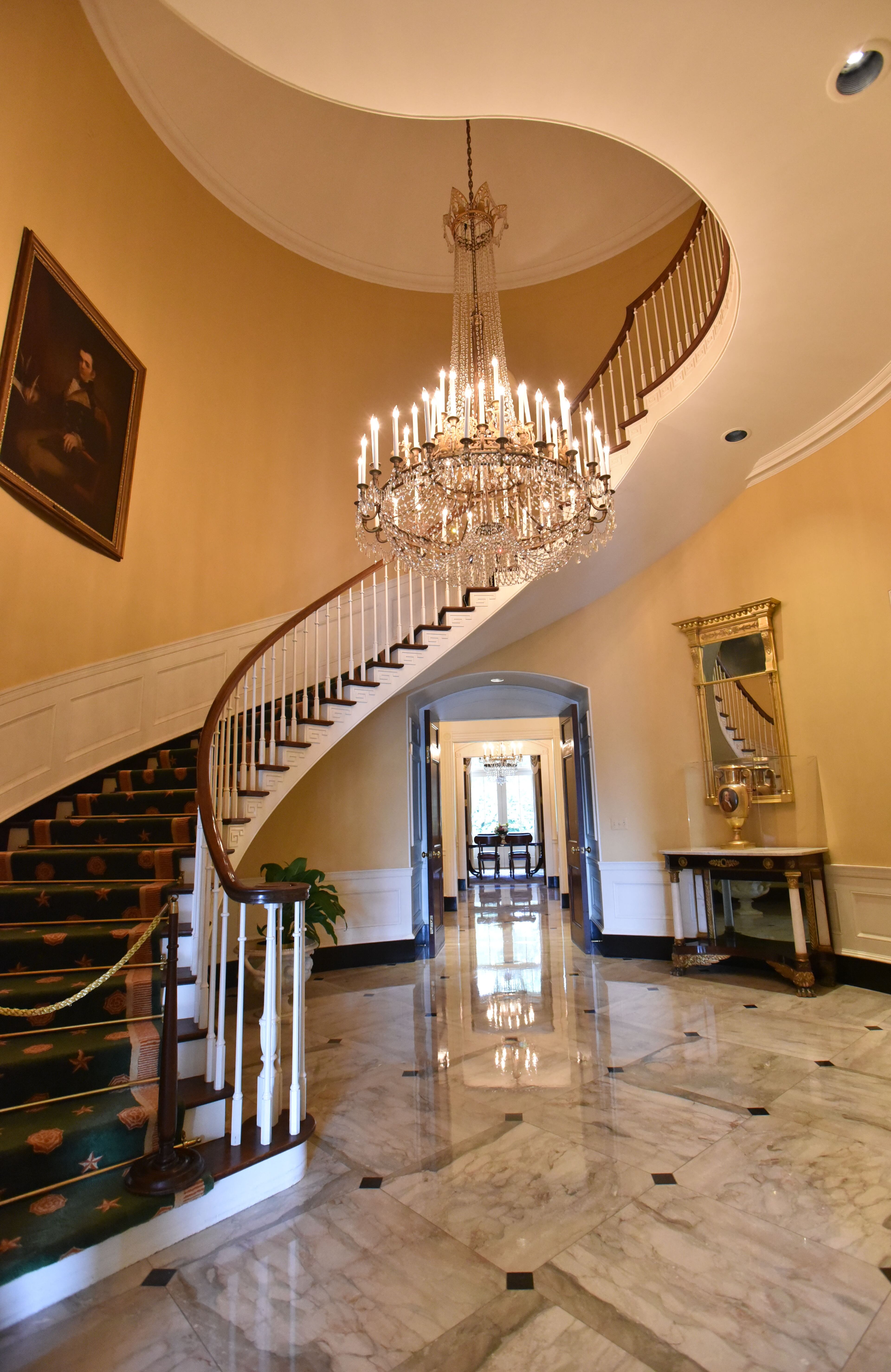 The circular hall at the Governor's Mansion is seen on Wednesday, Sept. 9, 2015. The chandelier is made from a modern American chandelier and a 19th Century Italian chandelier (which were salvaged from the former Standard Club in Atlanta). Sufficient pieces from each chandelier were combined to make this addition to the Mansion. HYOSUB SHIN / HSHIN@AJC.COM