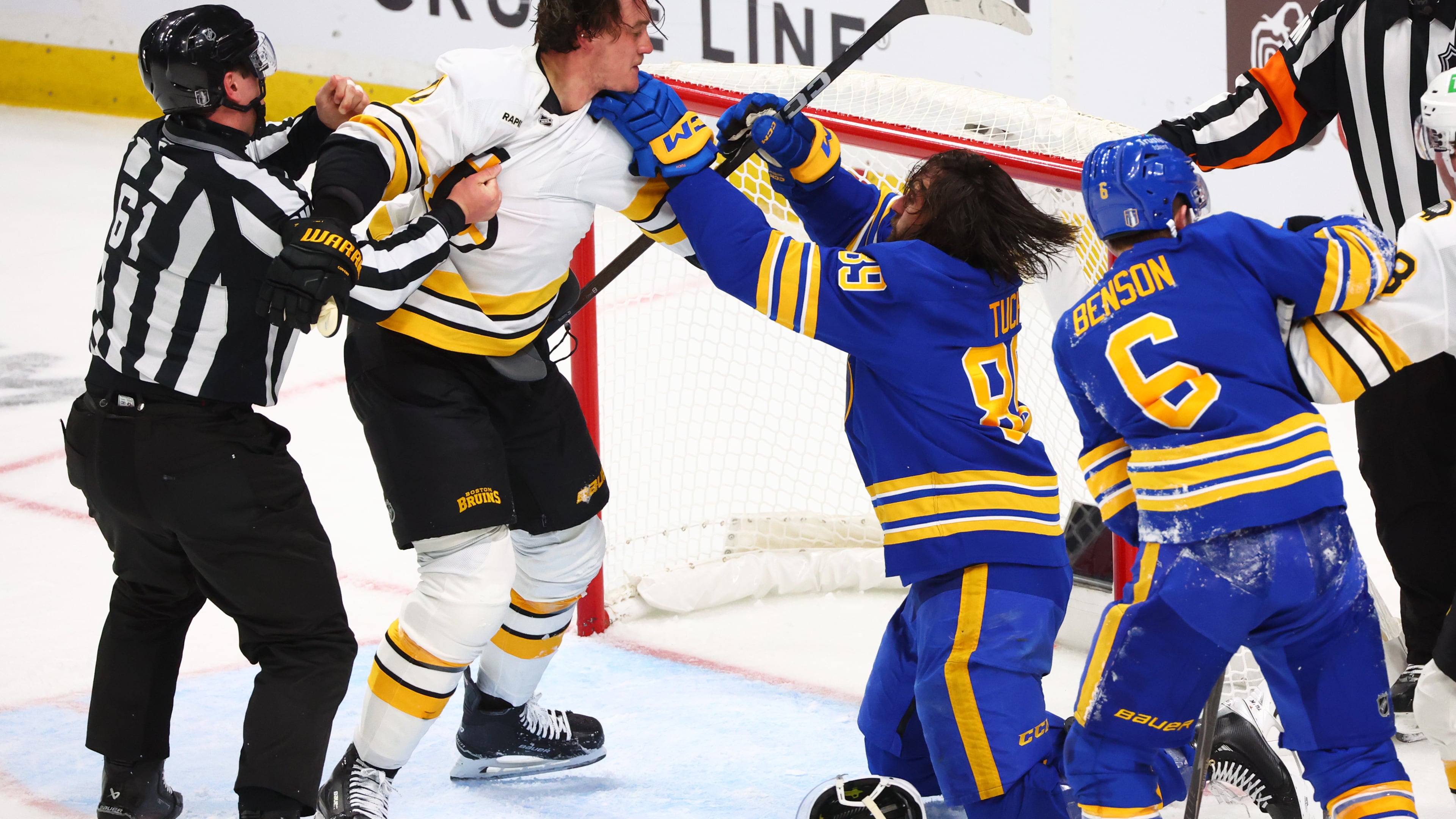 Boston Bruins defenseman Nikita Zadorov (91) and Buffalo Sabres right wing Alex Tuch (89) fight during the third period in Game 2 of a first-round NHL hockey Stanley Cup playoff series Tuesday, April 21, 2026, in Buffalo, N.Y. (AP Photo/Jeffrey T. Barnes)