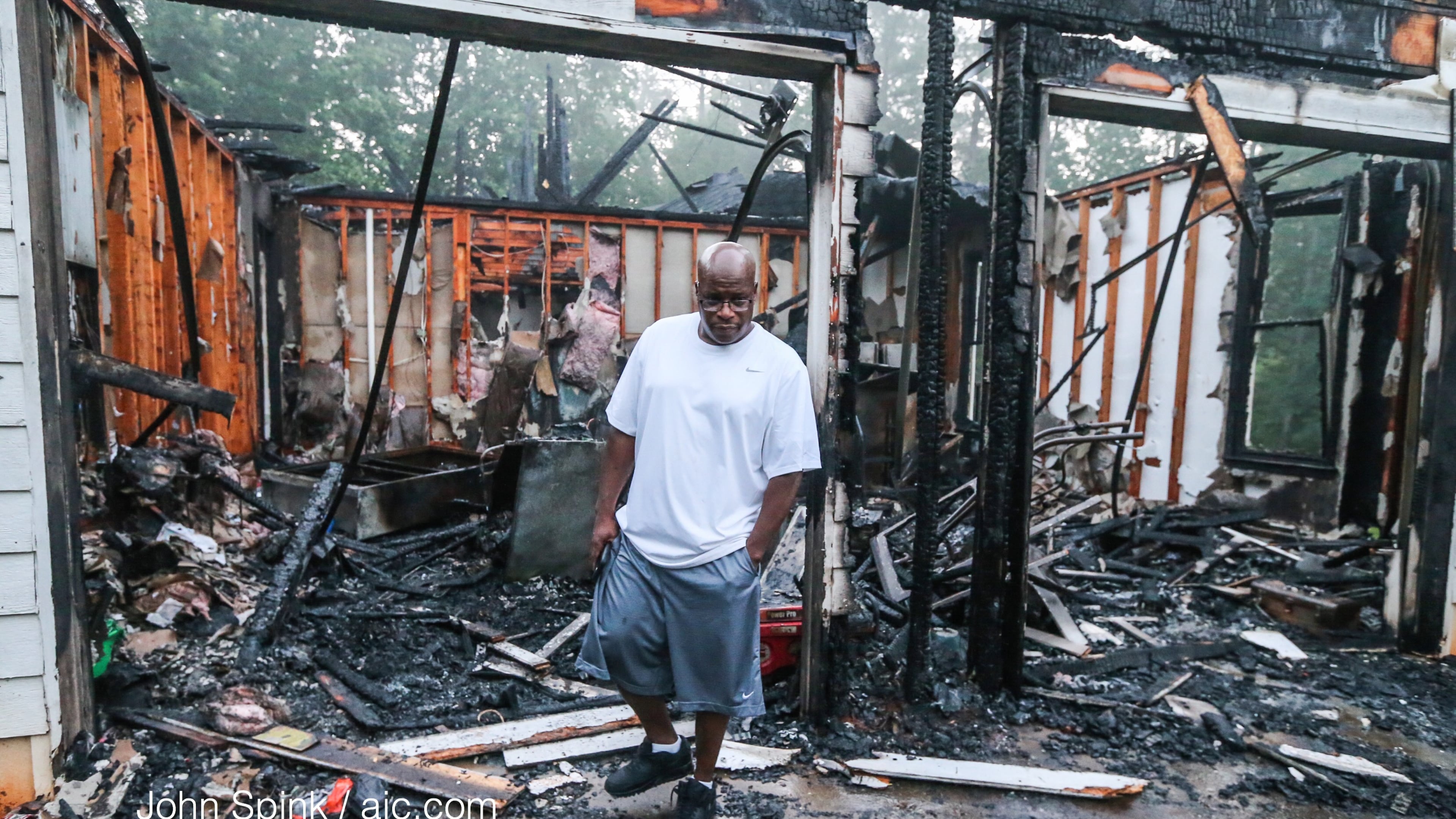 Bill Thomas walked through his mother’s burned home after a fire in DeKalb County. JOHN SPINK / JSPINK@AJC.COM