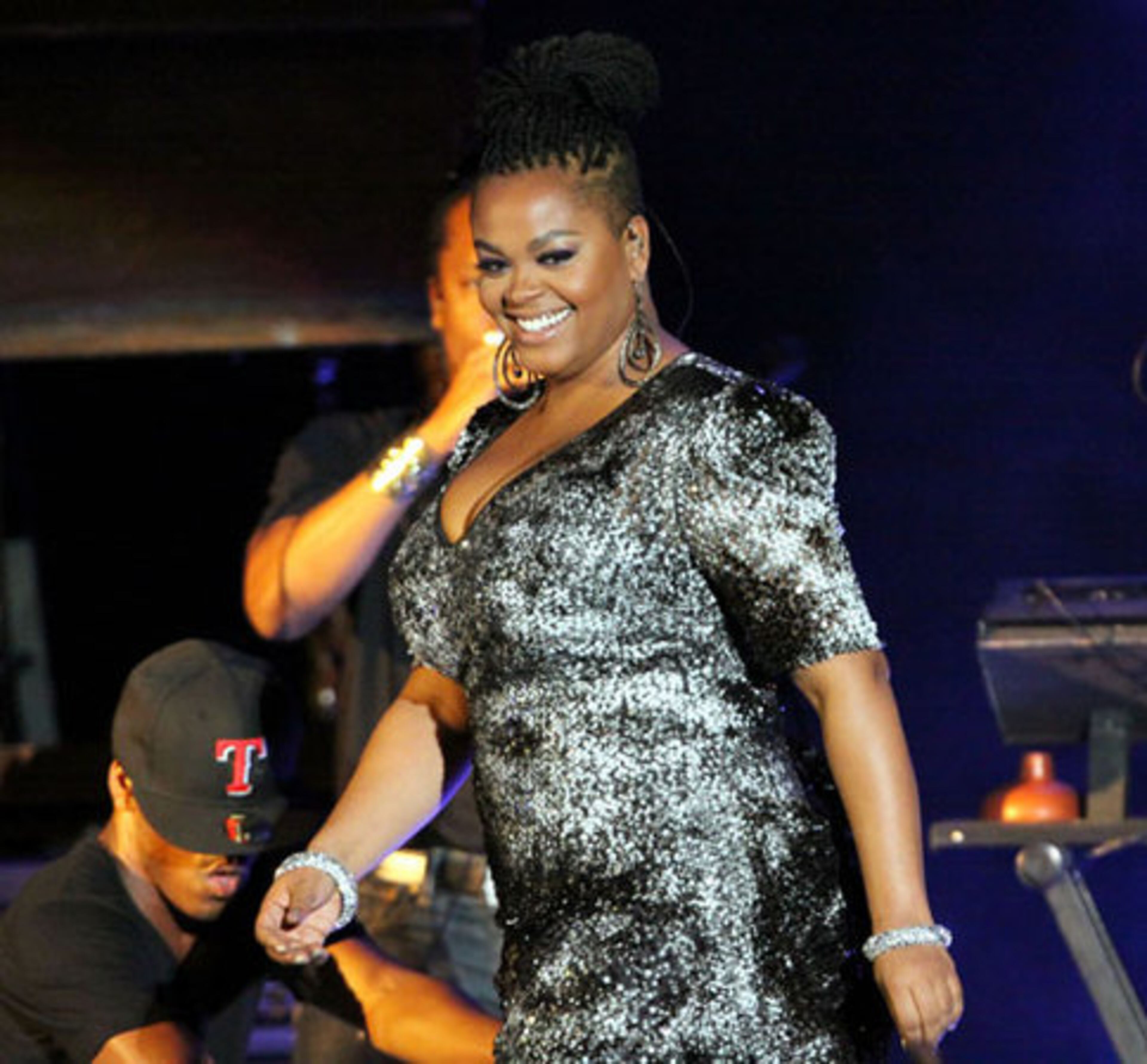 Jill Scott smiles at audience members as she makes her way to the microphone Friday, Aug. 20, 2011 on the first night of her two-night stand at Chastain Park Amphitheatre.