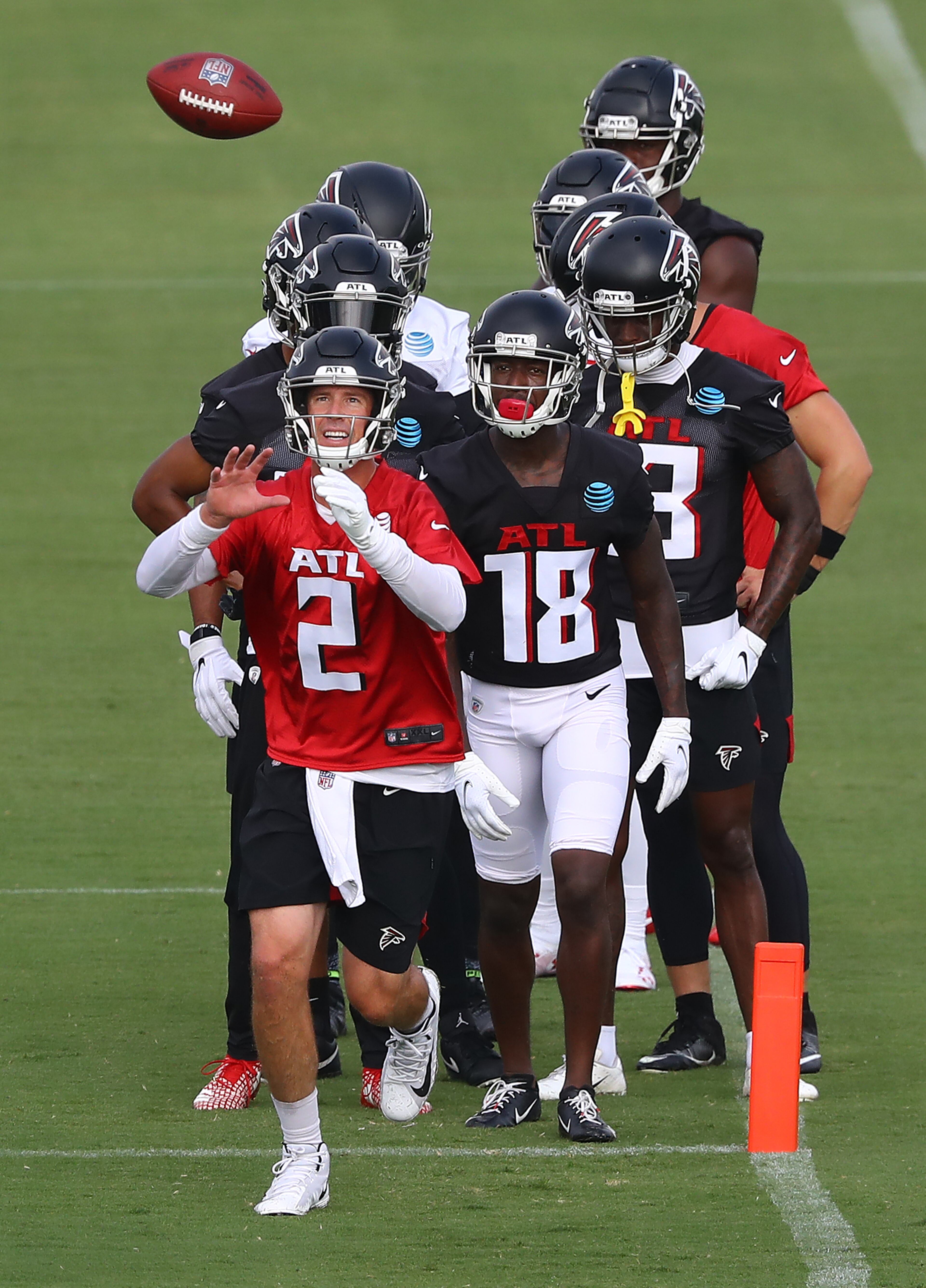 Falcons quarterback Matt Ryan (2) leads wide receiver Calvin Ridley (18) and a group of other wide receivers through a ball-handling drill during training camp on Saturday, August 15, 2020 in Flowery Branch. Curtis Compton ccompton@ajc.com