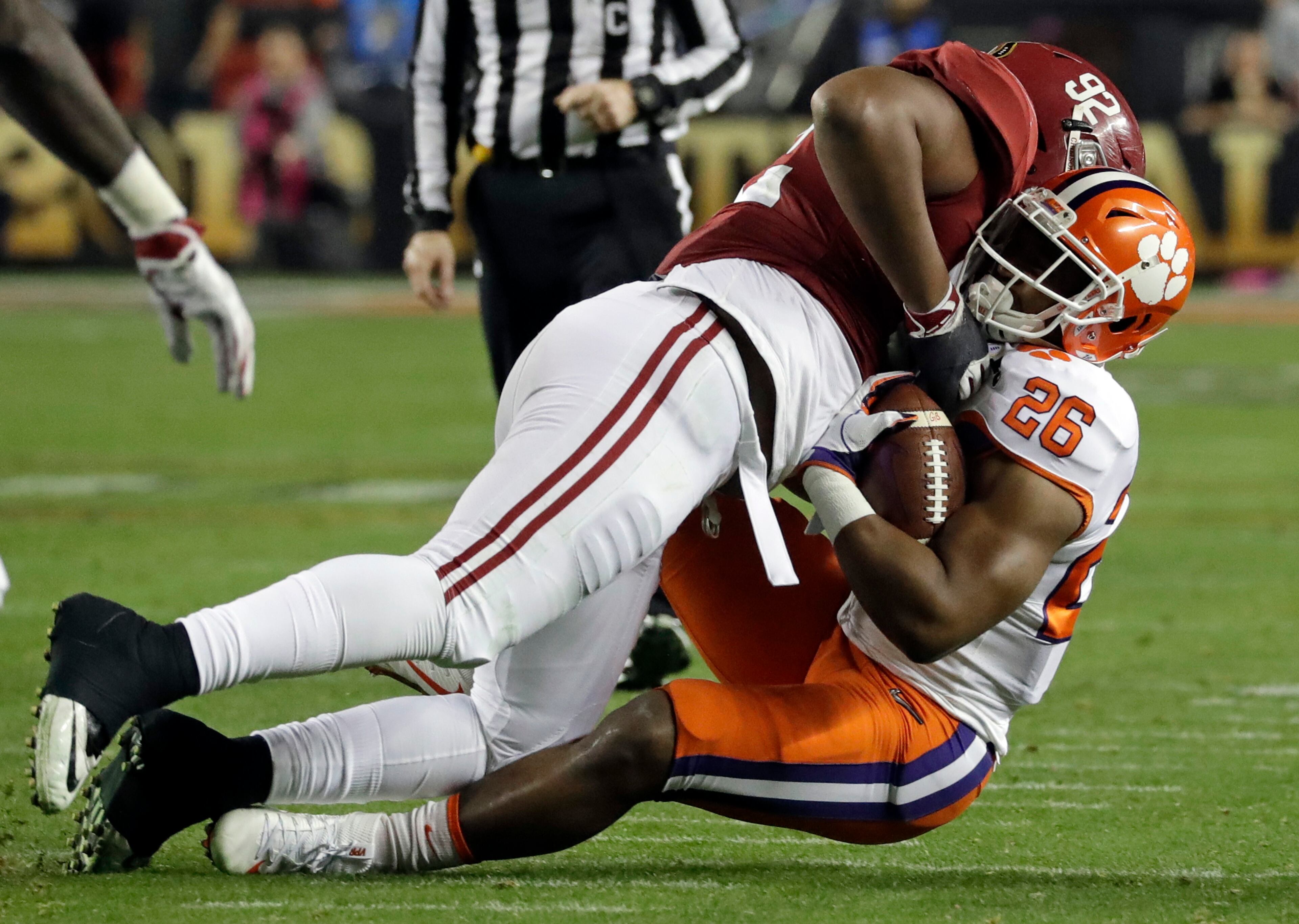 Clemson's Adam Choice is stopped by Alabama's Quinnen Williams during the first half of the NCAA college football playoff championship game Monday, Jan. 7, 2019, in Santa Clara, Calif.