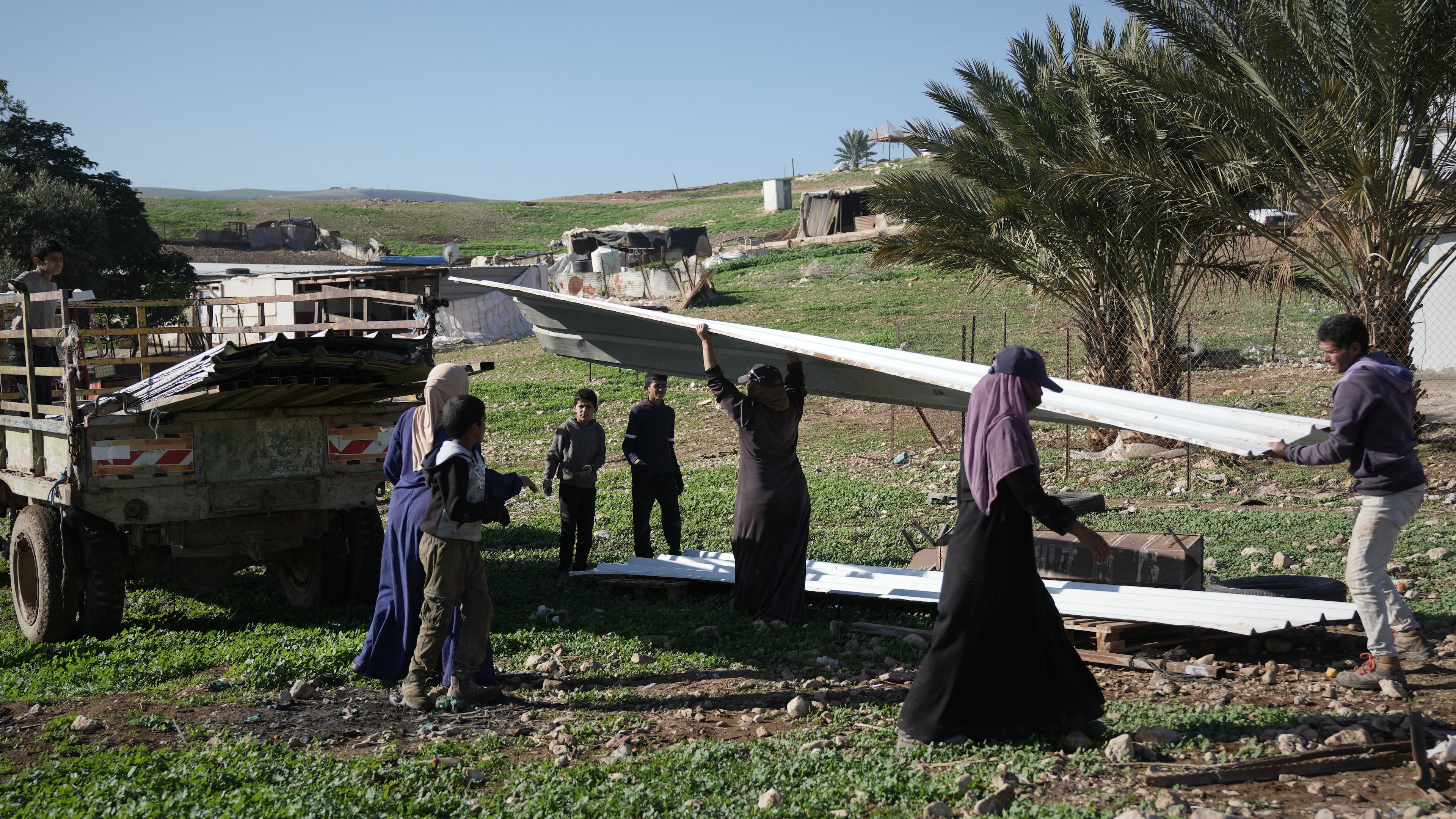 Palestinian residents of Ras Ein al-Auja village, West Bank pack up their belongings and prepare to leave their homes after deciding to flee mounting settler violence, Sunday, Jan. 11, 2026. (AP Photo/Mahmoud Illean)