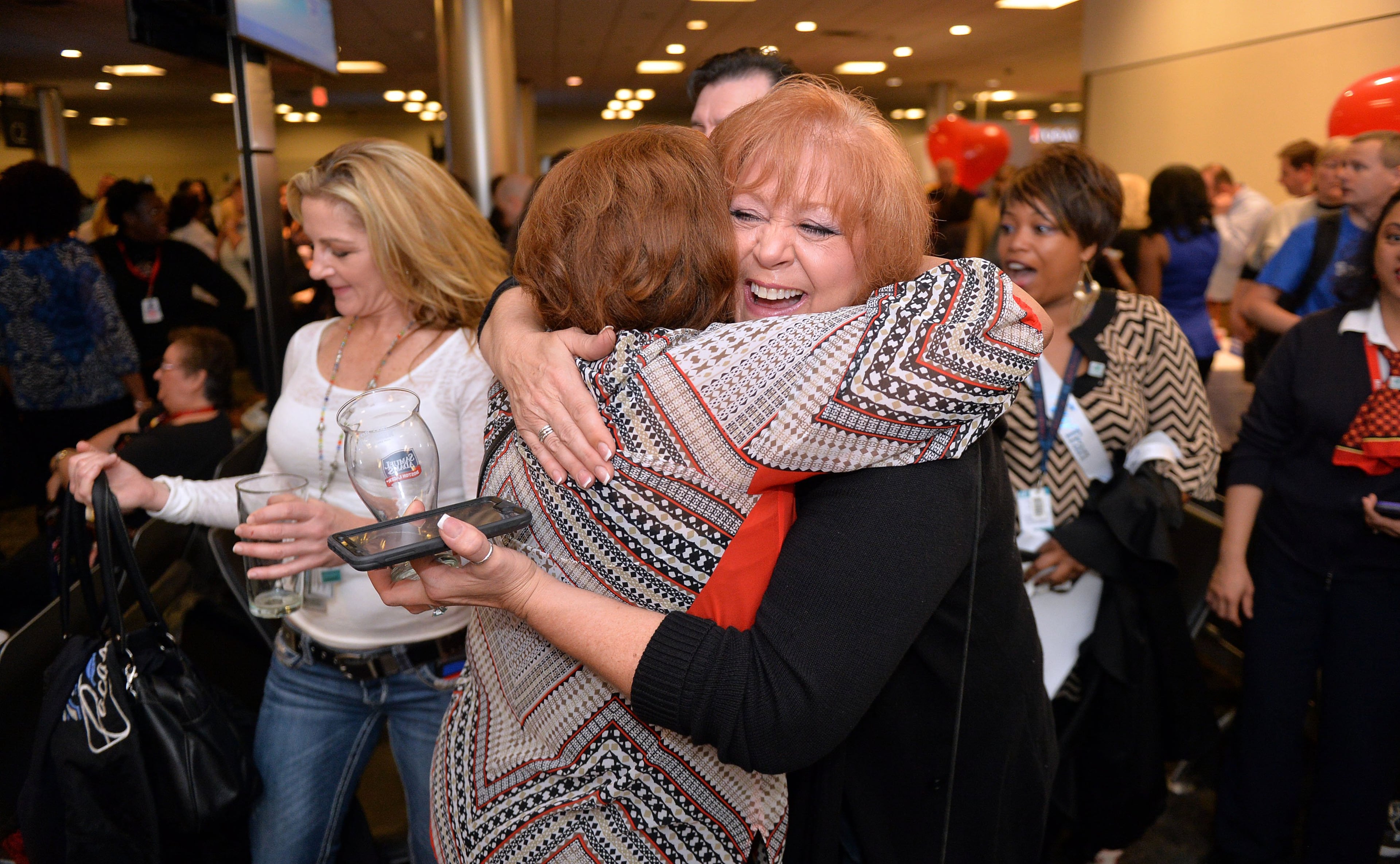 Hundreds of Southwest Airlines and former AirTran Airways employees gathered at Concourse C, gates 1, 2 and 3 to celebrate the departure of AirTran’s final flight to Tampa, at Hartsfield-Jackson International Airport, Sunday, December 28, 2014. Southwest CEO Gary Kelly and executives Bob Jordan and Jack Smith gave remarks during the program. The full flight was waved off by employees that gathered on the tarmac as crash trucks from Atlanta Fire Rescue gave a final water cannon salute as the plane departed. KENT D. JOHNSON/KDJOHNSON@AJC.COM