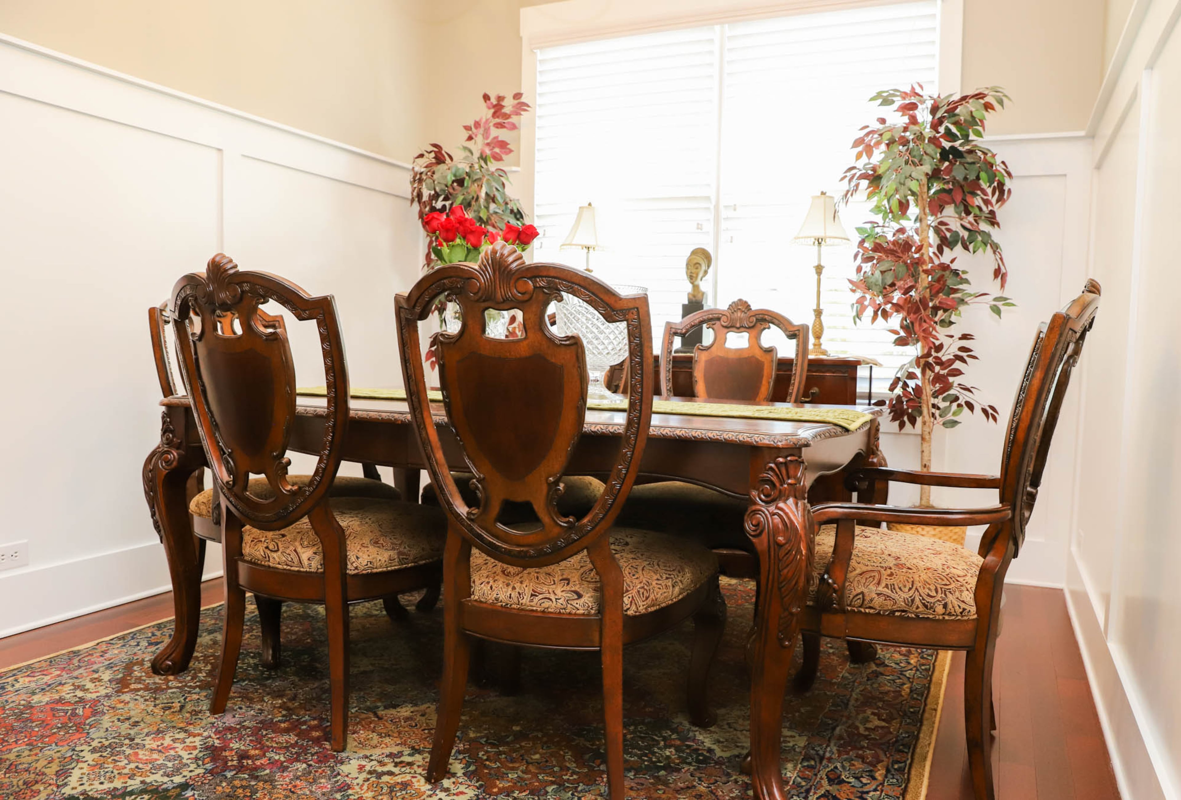 The dining room of Gail Burns-Grant’s home is warm and elegant, with a table and chairs from Macy’s Furniture Gallery and a rug by Karastan. Burns-Grant loves to entertain, so when she was looking for the perfect home, a dining room was on her must-have list. Text by Shannon Dominy/Photo by Reynolds Rogers