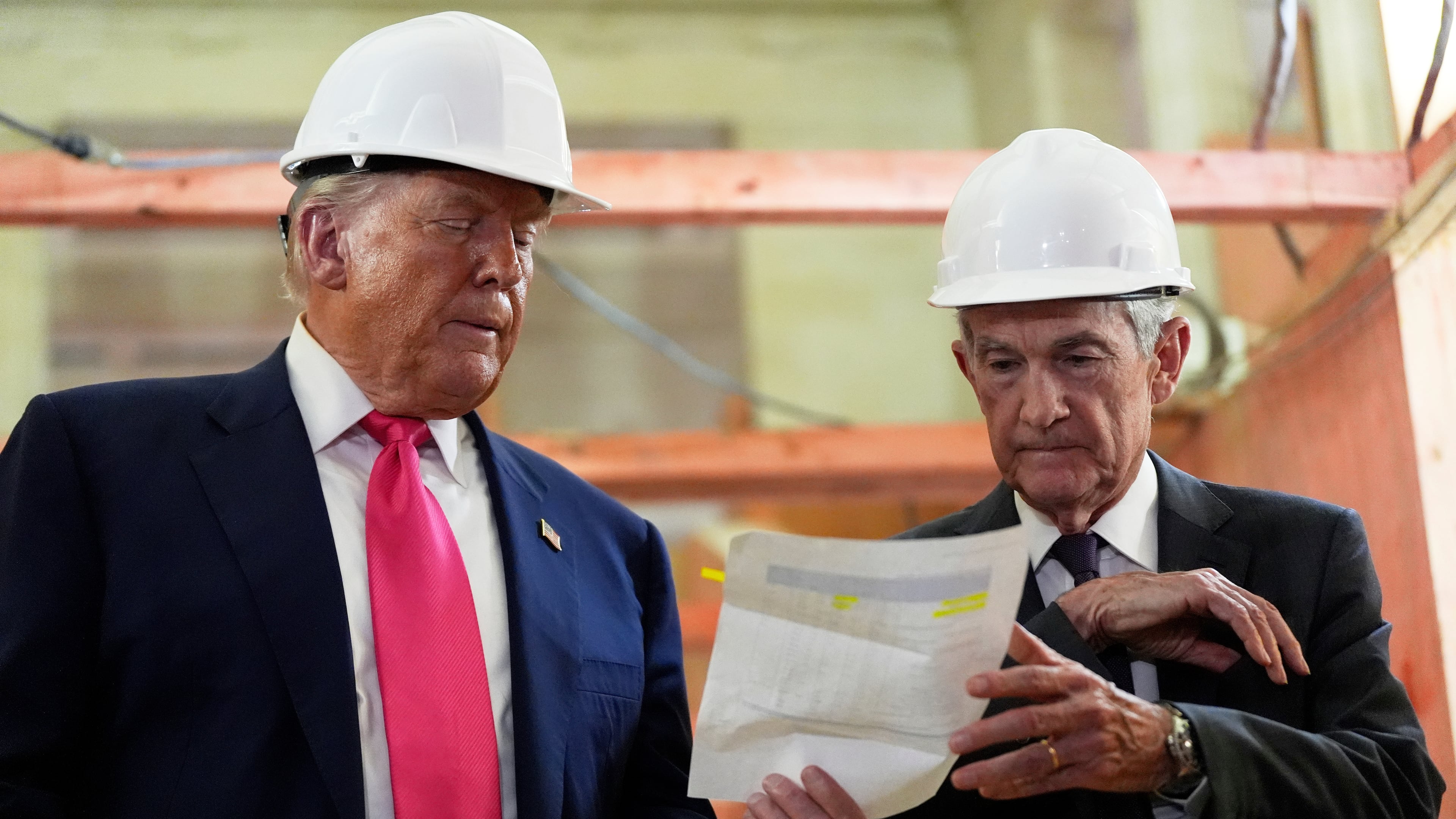 FILE- FILE - Federal Reserve Chairman Jerome Powell, right, and President Donald Trump look over a document of cost figures during a visit to the Federal Reserve, Thursday, July 24, 2025, in Washington. (AP Photo/Julia Demaree Nikhinson, File)
