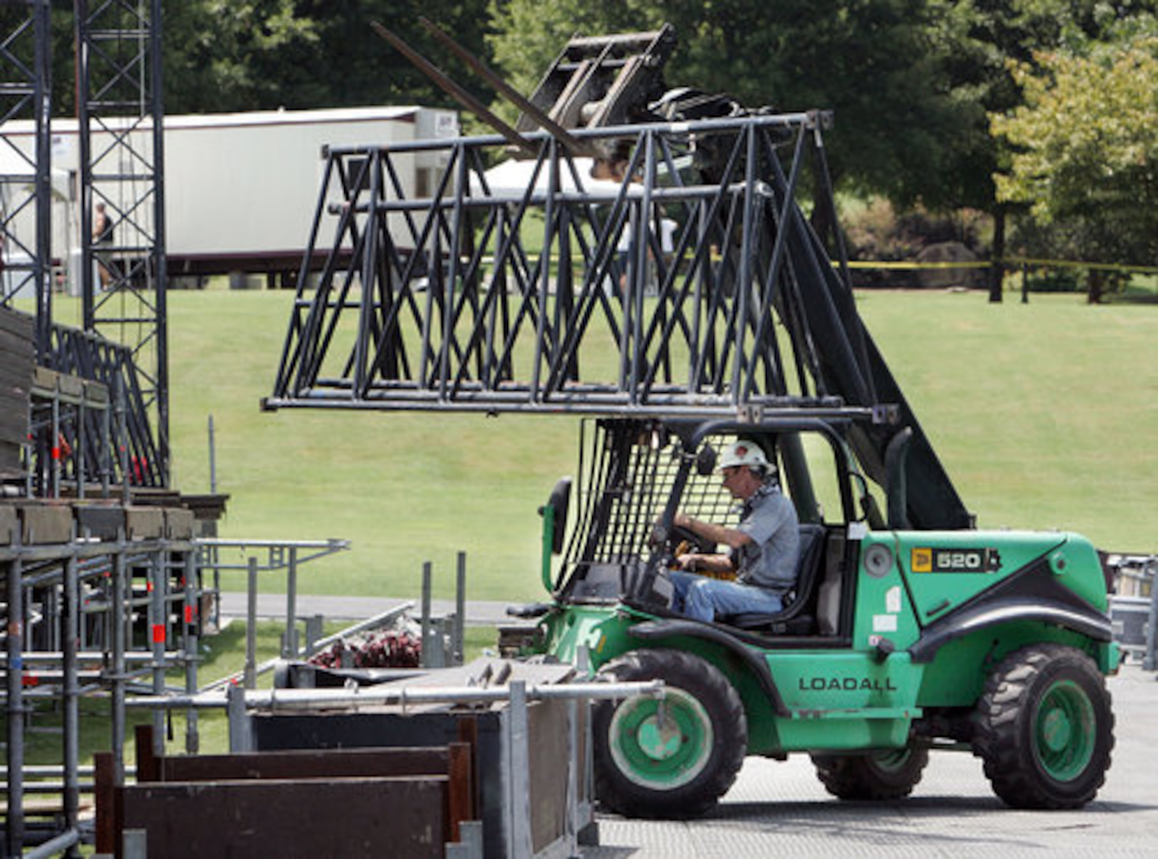 Crew Master Eddie Shugart transports trusses for the superstructures of the massive stage.