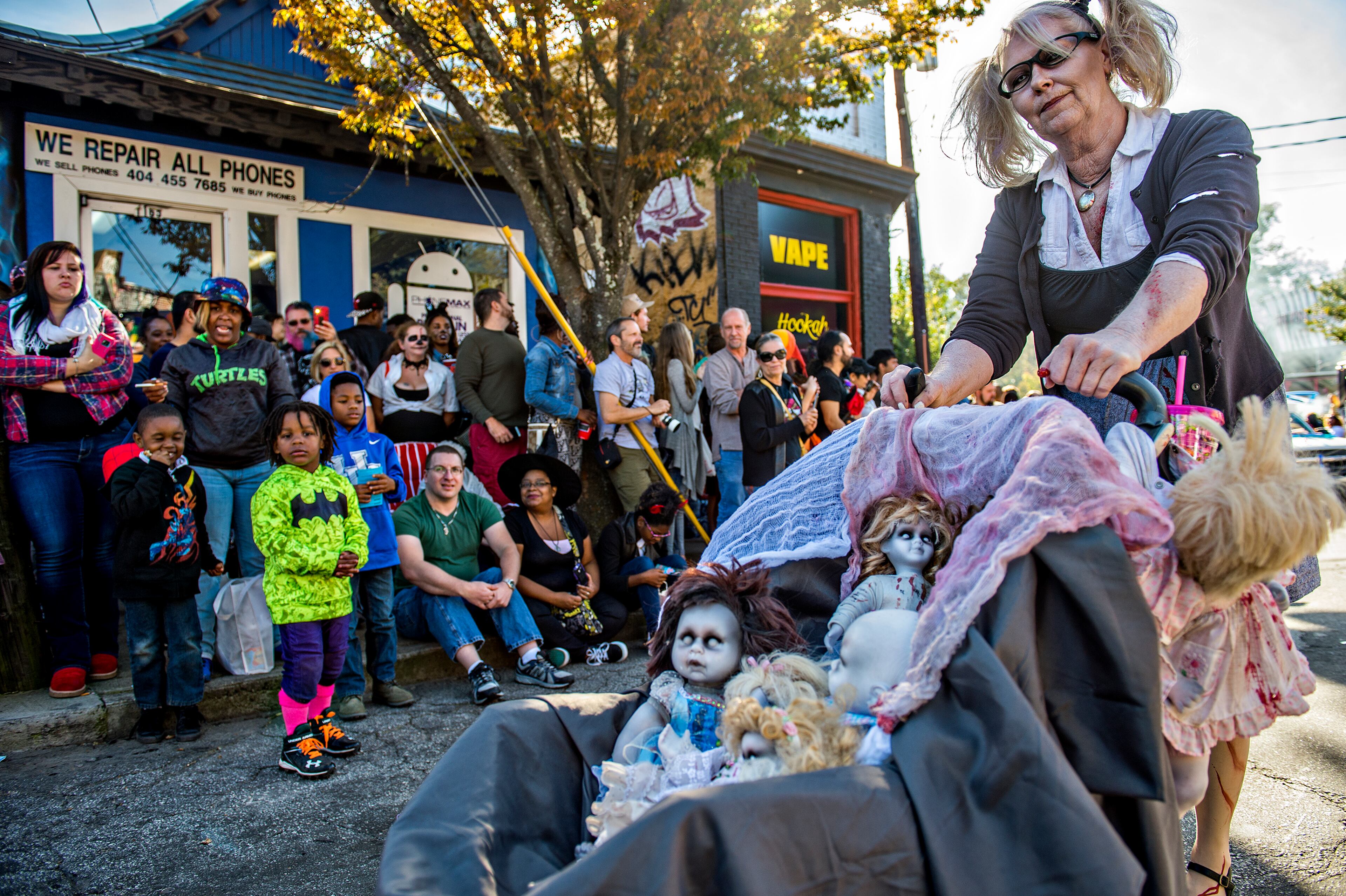 October 17, 2015 Atlanta - Chris Schott (right) pushes her dolls in a stroller during the Little Five Points Halloween Parade in Atlanta on Saturday, October 17, 2015. The annual parade brought out tens of thousands of people to watch the antics. JONATHAN PHILLIPS / SPECIAL