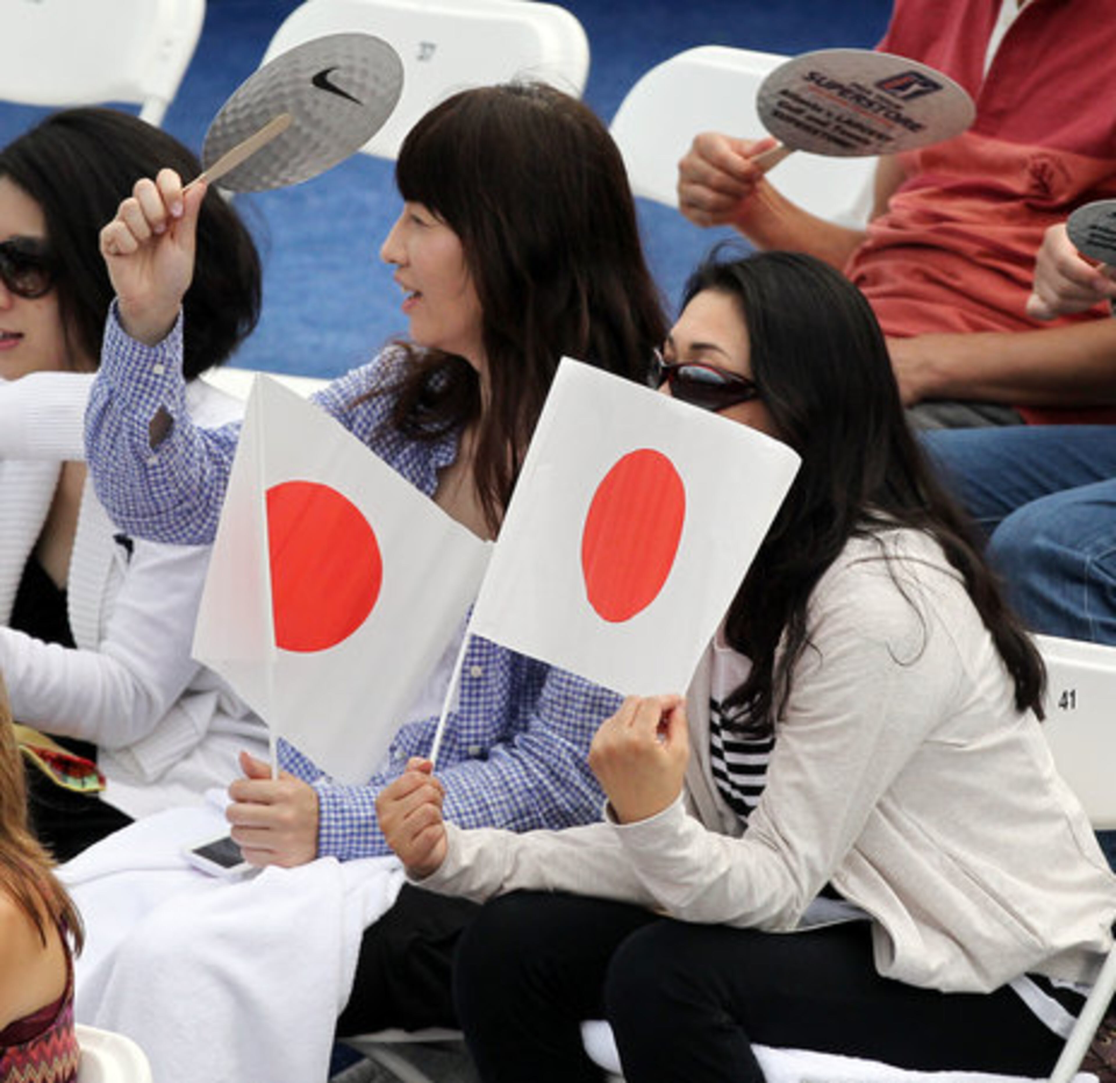 Tennis fans hold Japanese flags in a show of support for two Japanese players Kei Nishikori and Go Soeda while they play in the quarterfinals at the Atlanta Open on Friday, July 20, 2012.