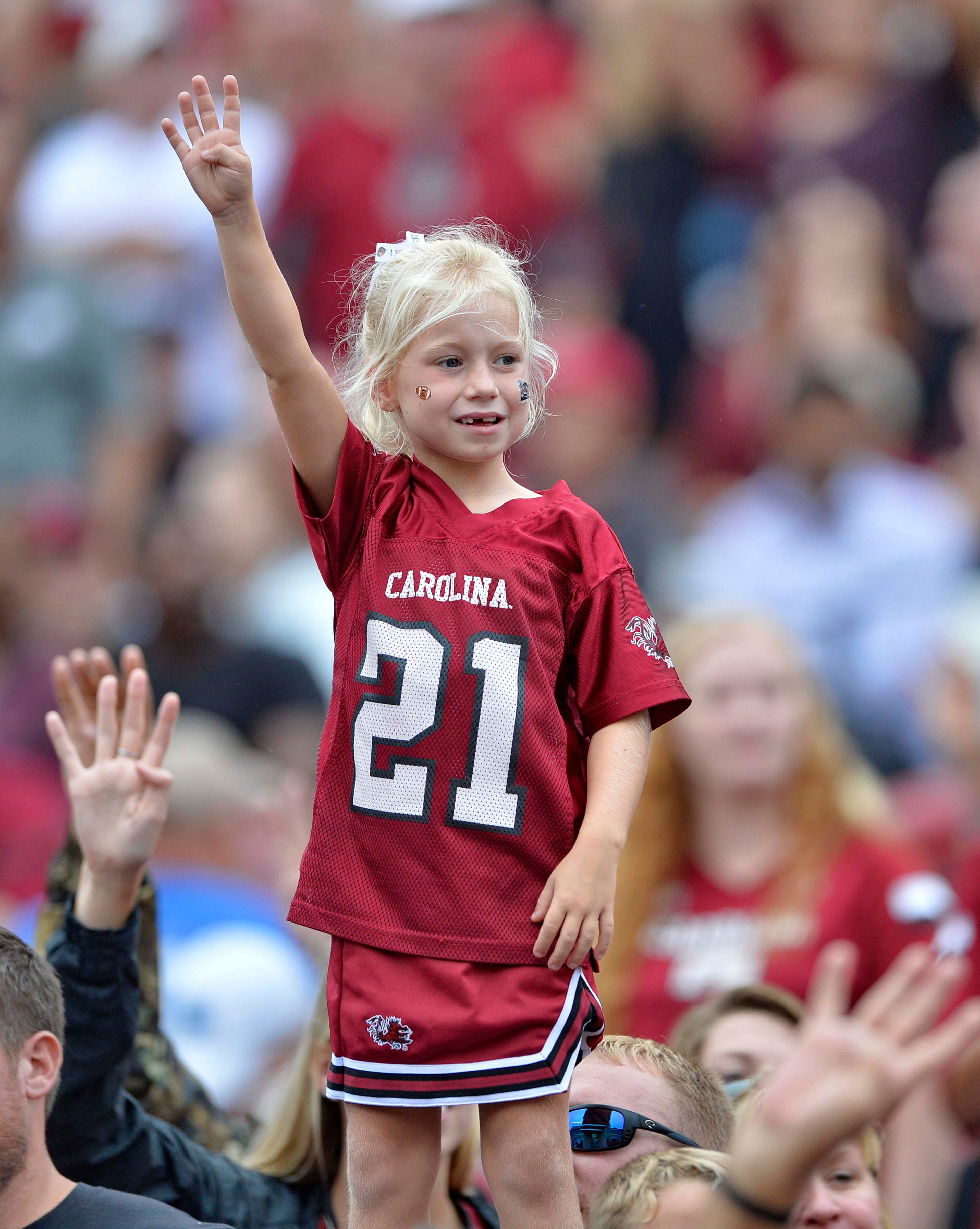 A young fan signals for the fourth quarter during the second half of an NCAA college football game against Central Florida Saturday, Sept. 26, 2015, in Columbia, S.C. South Carolina won 31-14. (AP Photo/Richard Shiro)