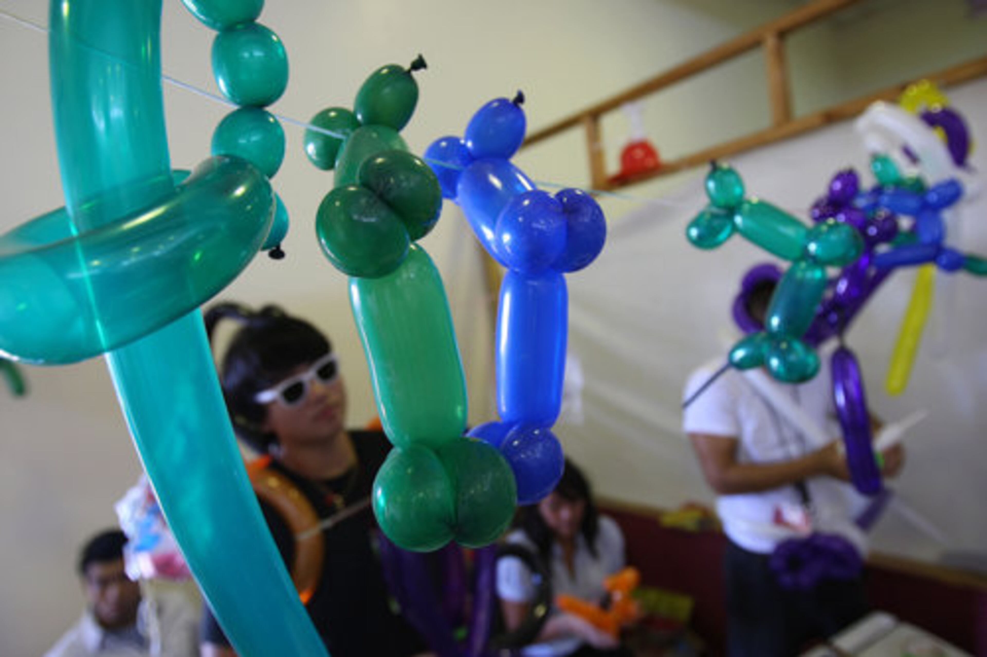 Volunteers help to sell animal balloons to raise money for the church during The Holy Martyrs of Vietnam Catholic Church's 2nd Annual Fall Festival in Norcross Sunday, September 5, 2010.