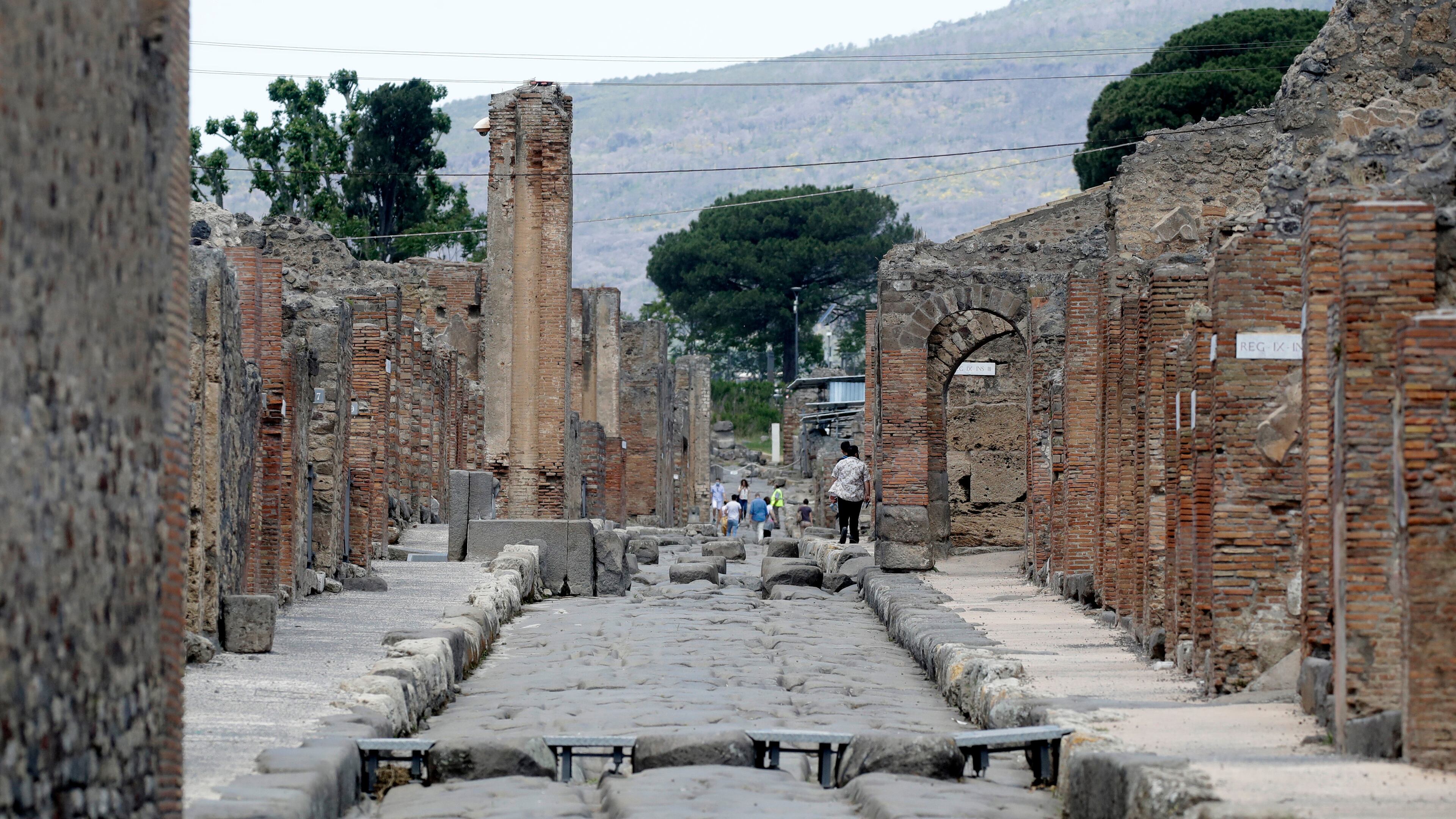 FILE -People visit the archaeological site of Pompeii, near Naples, southern Italy,Tuesday, May 26, 2020. (AP Photo/Alessandra Tarantino, File)