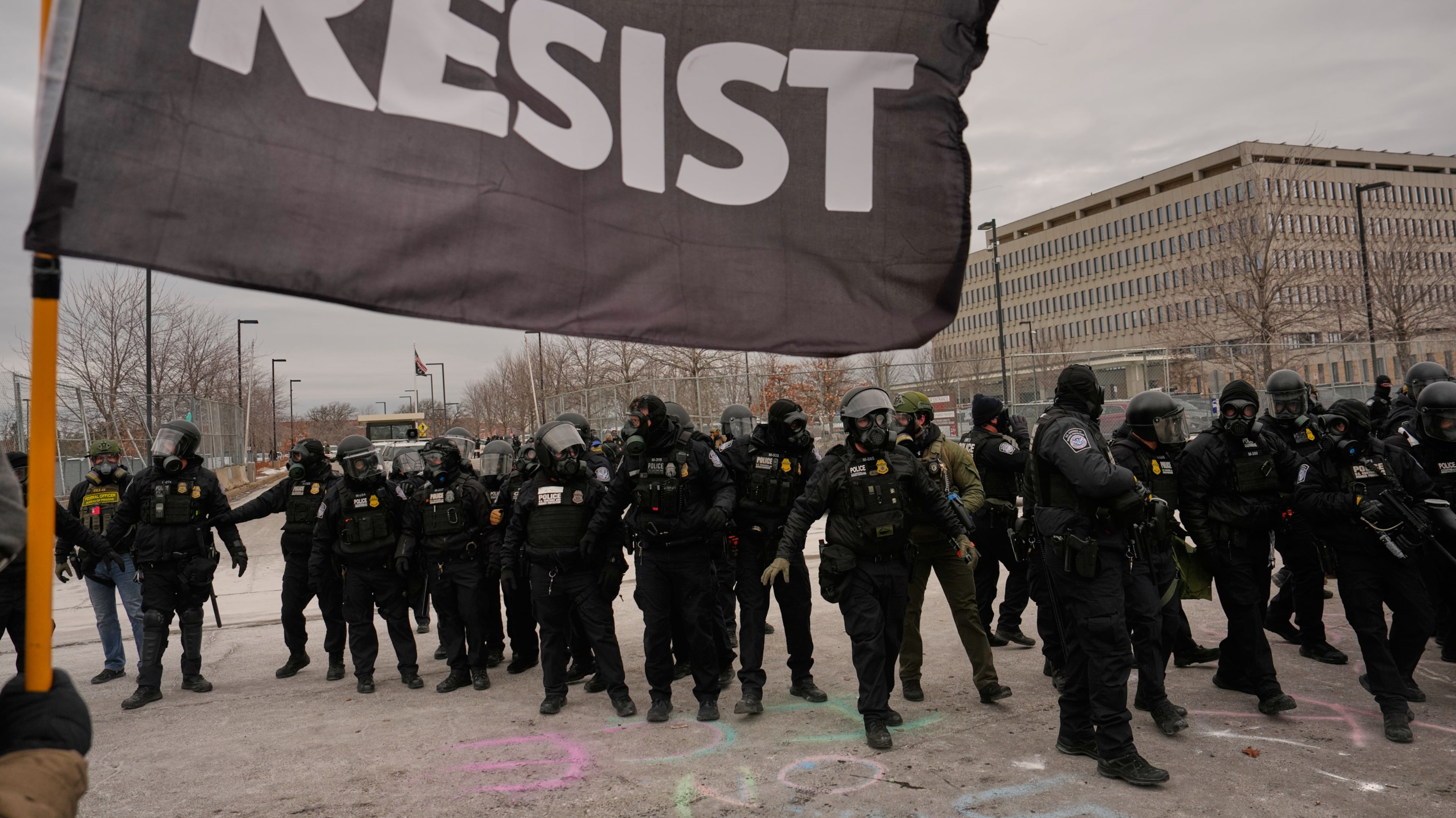 FILE - Federal immigration officers confront protesters outside Bishop Henry Whipple Federal Building, Jan. 15, 2026, in Minneapolis. (AP Photo/John Locher, File)