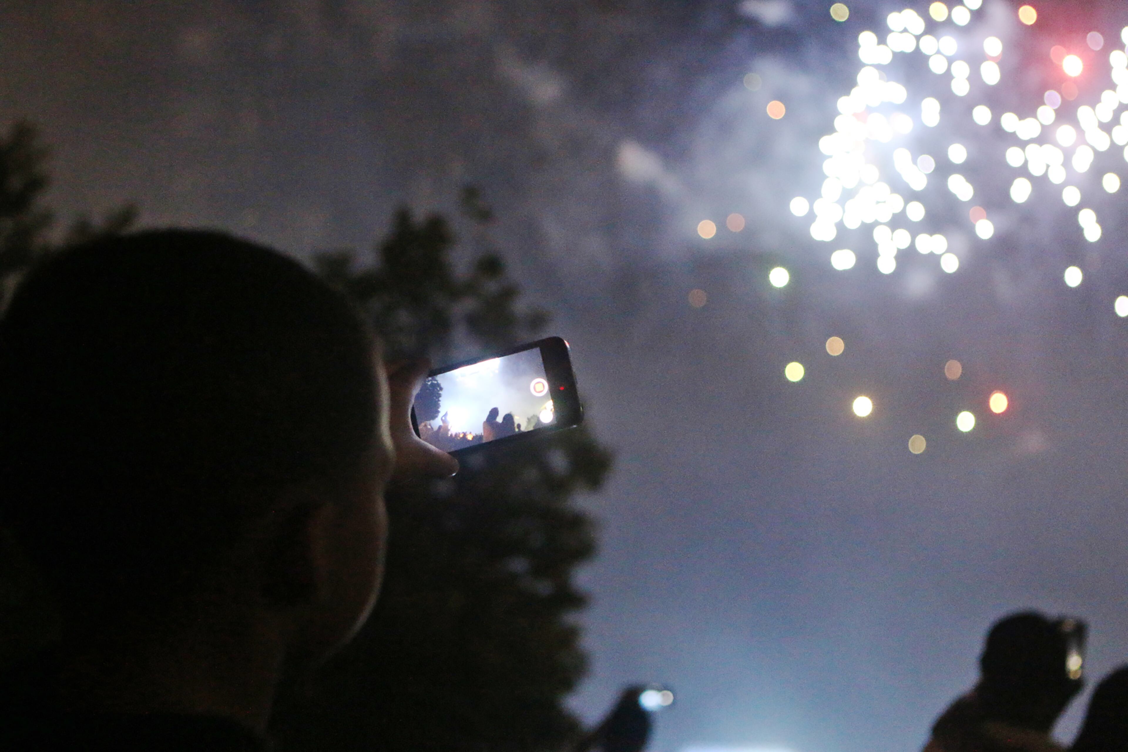 A young spectator shoots video of the fireworks display at Centennial Olympic Park. Christina Matacotta/Christina.Matacotta@ajc.com