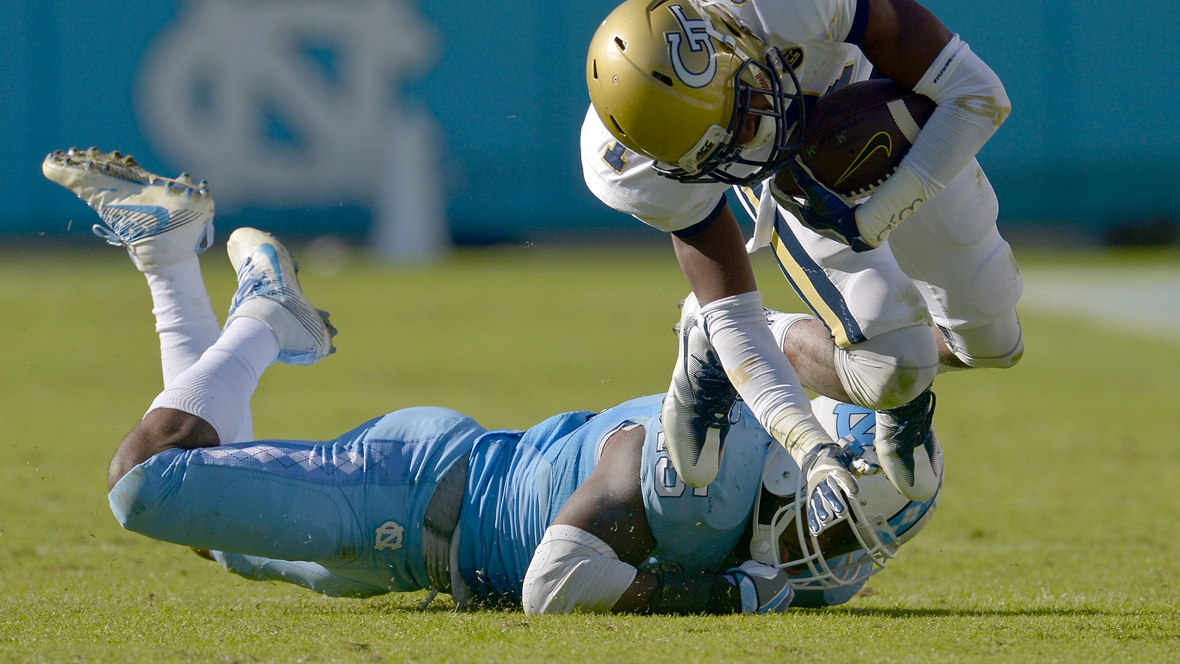 Donnie Miles #15 of the North Carolina Tar Heels trips up Qua Searcy #1 of the Georgia Tech Yellow Jackets during the game at Kenan Stadium on November 5, 2016 in Chapel Hill, North Carolina. North Carolina won 48-20. (Photo by Grant Halverson/Getty Images)