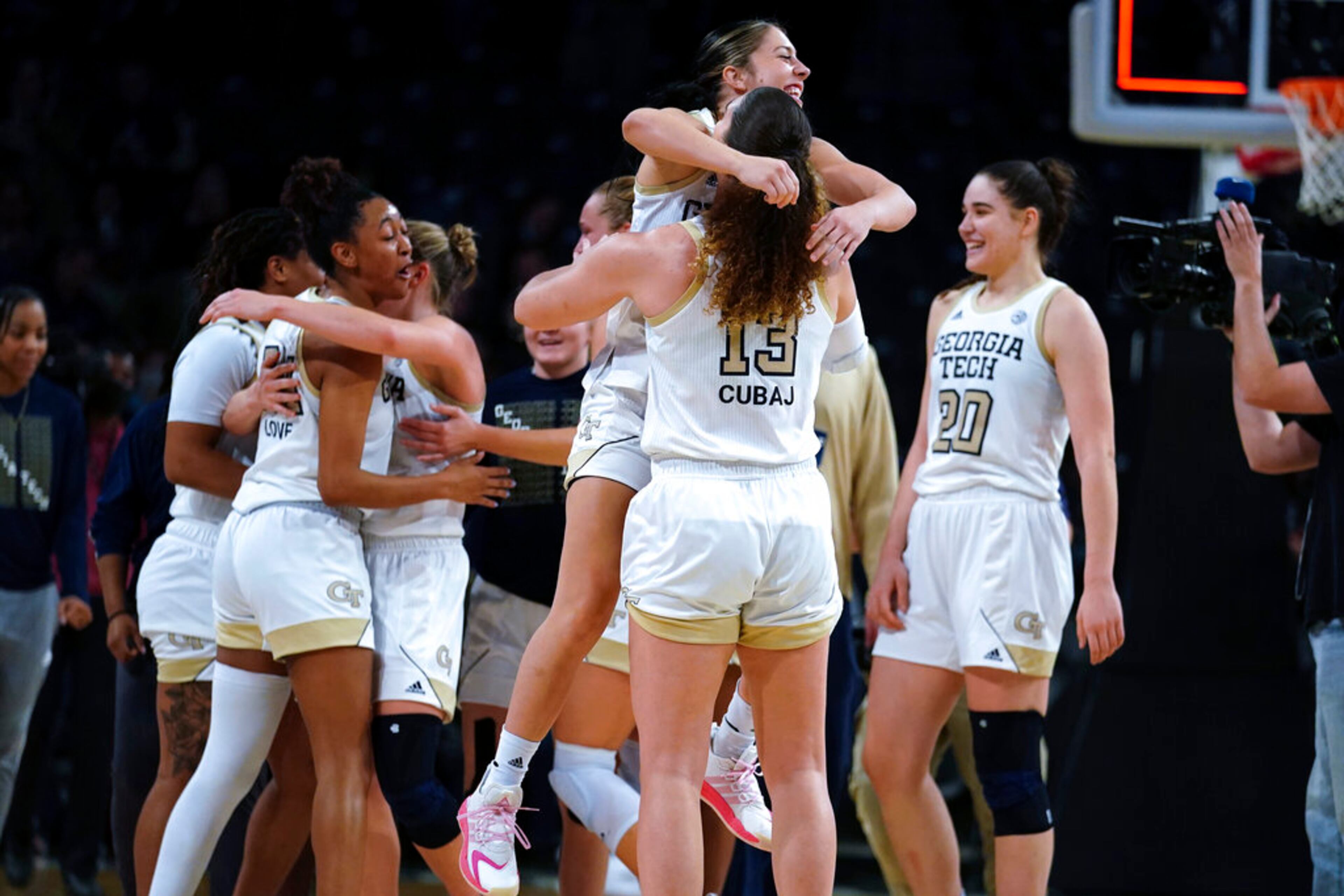 Georgia Tech's Sarah Bates (3) and Lorela Cubaj (13) celebrate after Georgia Tech defeated Connecticut in an NCAA college basketball game Thursday, Dec. 9, 2021, in Atlanta. (AP Photo/John Bazemore)