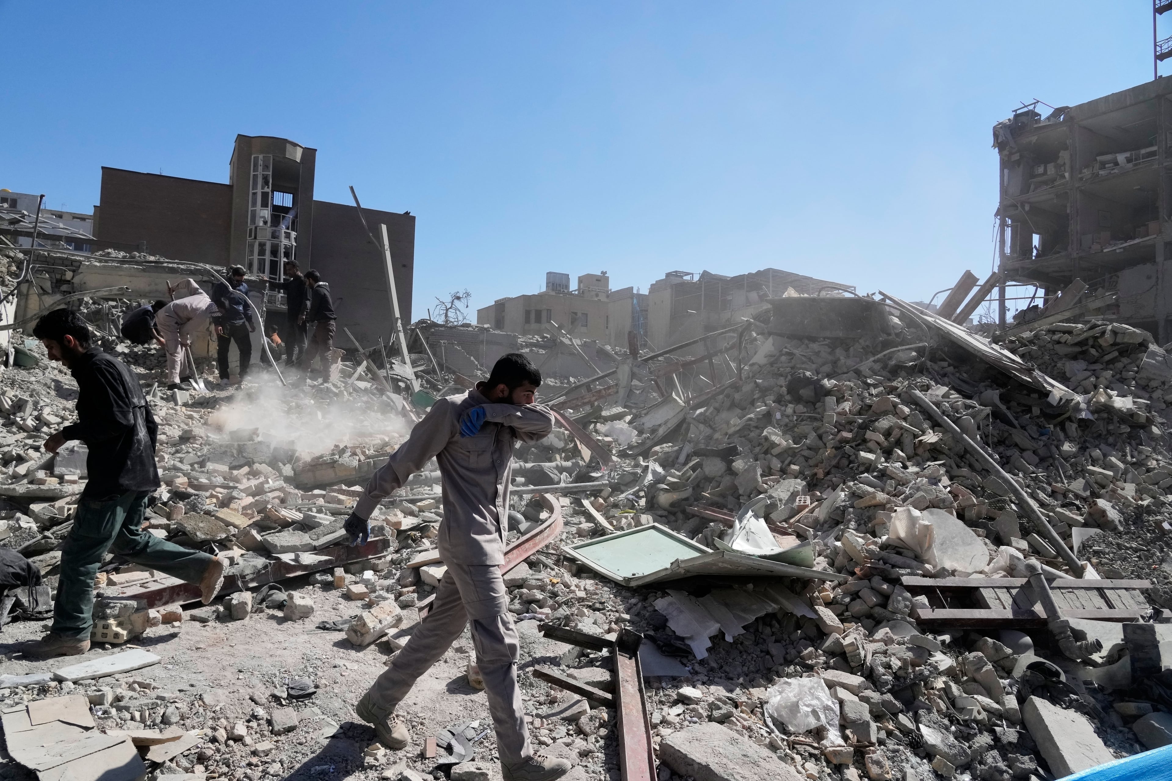 A group of men inspected the ruins of a police station struck Monday amid the U.S.–Israeli military campaign in Tehran, Iran. (Vahid Salemi/AP)