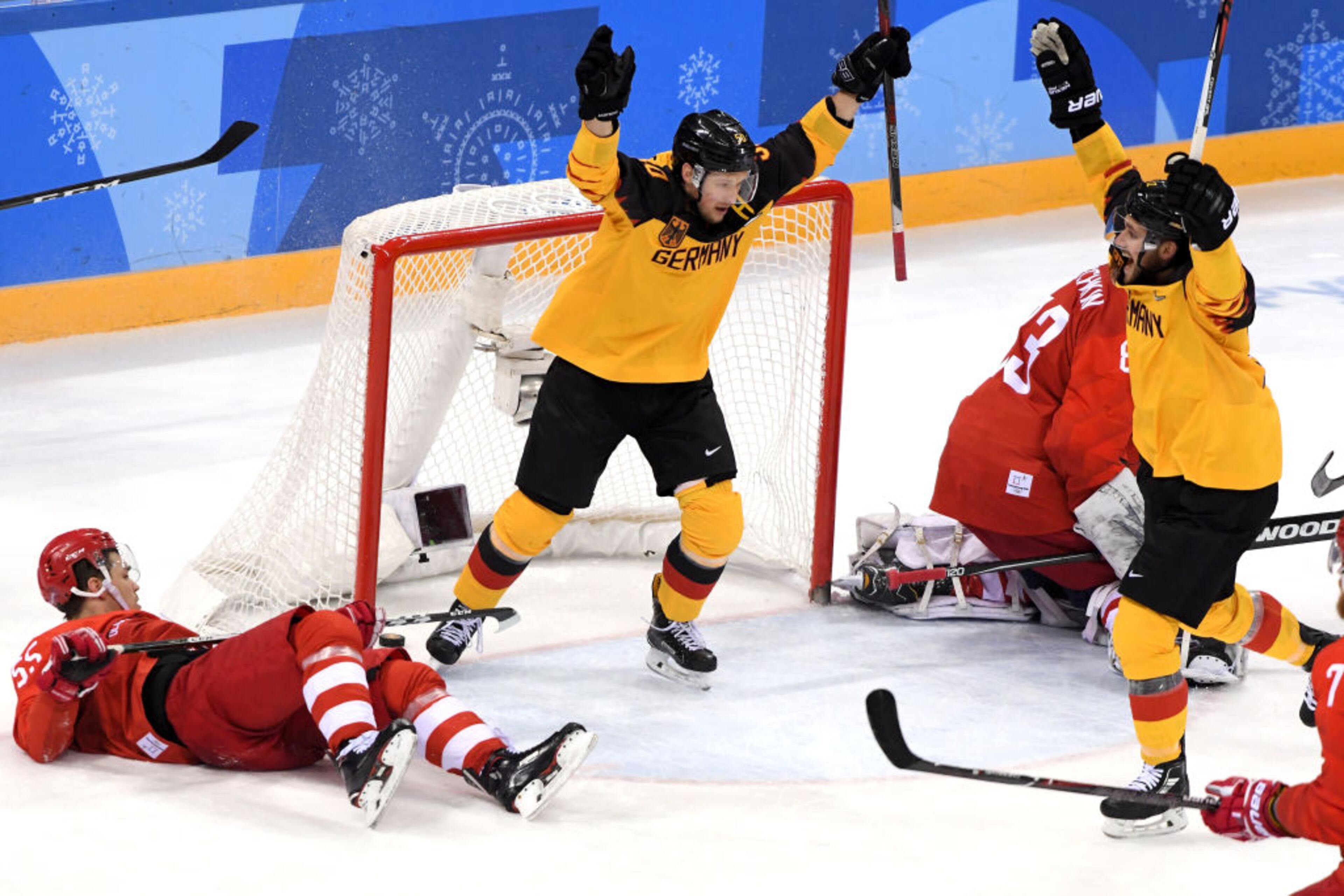 GANGNEUNG, SOUTH KOREA - FEBRUARY 25: Brooks Macek #12 and Patrick Hager #50 of Germany celebrate after a goal by teammate Felix Schutz #55 (not pictured) in the second period against Vasili Koshechkin #83 of Olympic Athlete from Russia during the Men's Gold Medal Game on day sixteen of the PyeongChang 2018 Winter Olympic Games at Gangneung Hockey Centre on February 25, 2018 in Gangneung, South Korea. (Photo by Harry How/Getty Images)
