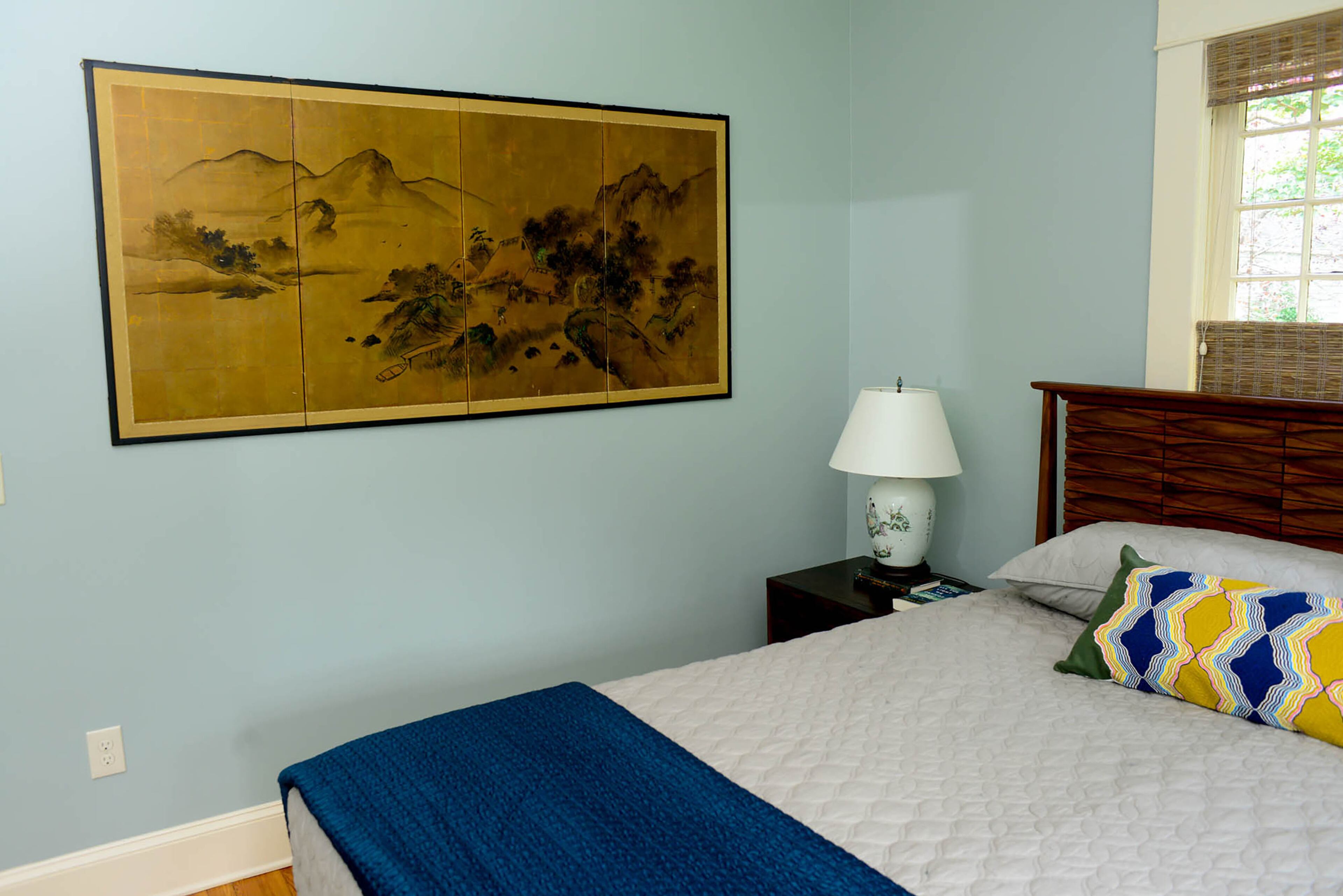 An Asian-style print in the master bedroom originally belonged to Grounds' parents and hung over their sofa. It's zen-like and fun, she said. It works with the soothing Sherwin-Williams Silvermist walls and the bed from AllModern.com.