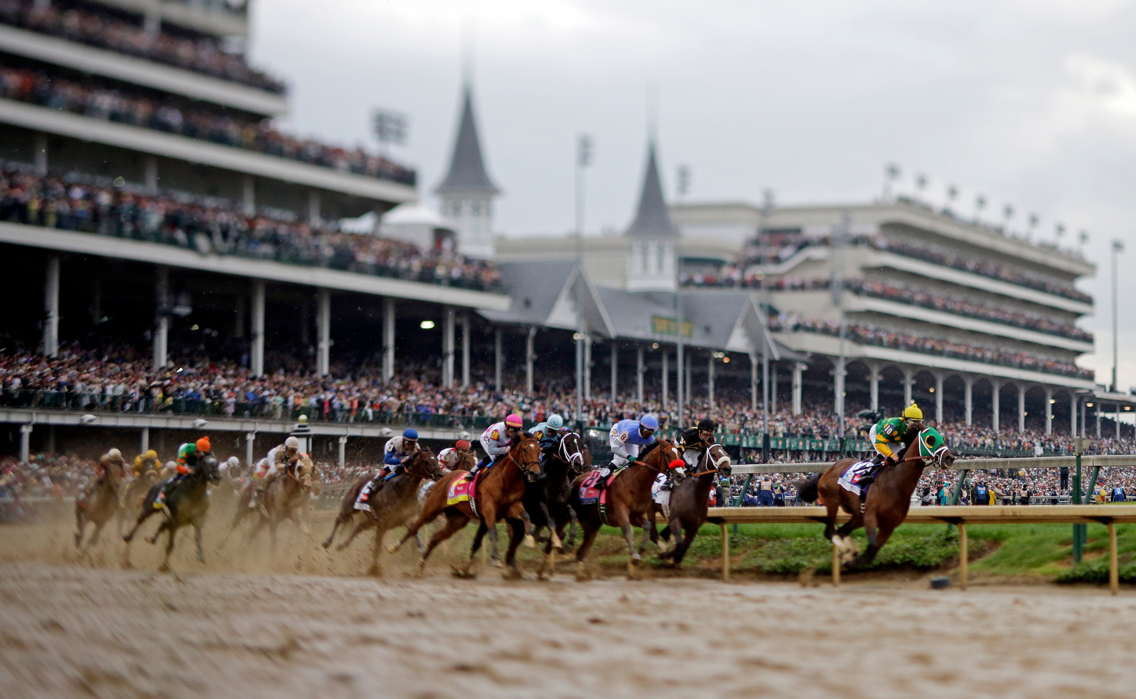 Horses make their way around turn one during the 139th Kentucky Derby at Churchill Downs Saturday, May 4, 2013, in Louisville, Ky. (AP Photo/Matt Slocum)
