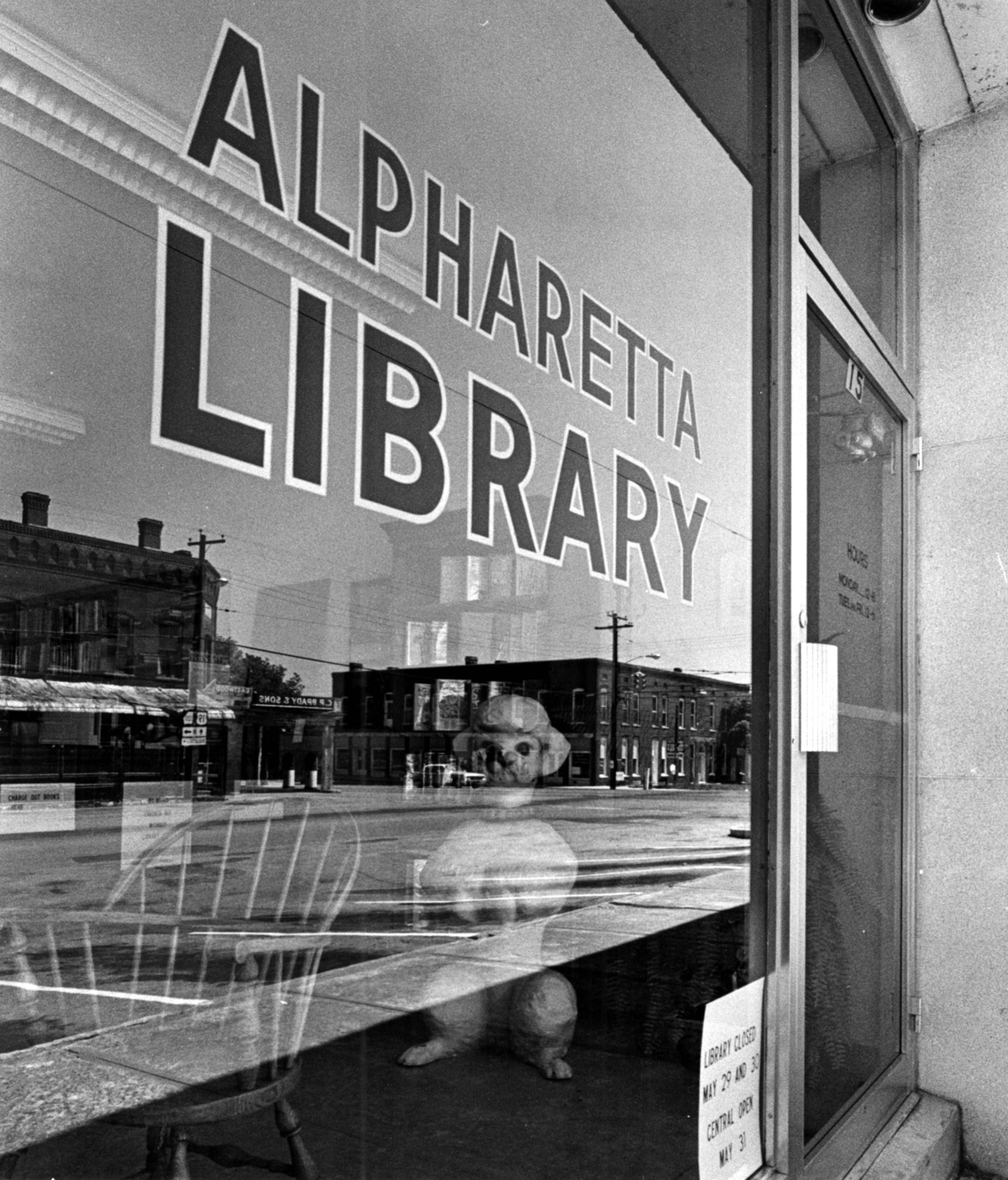 Alpharetta, Ga.: On a window of the public library, image of downtown area is reflected on the glass. (Staff photo-Robert Connell) 1970