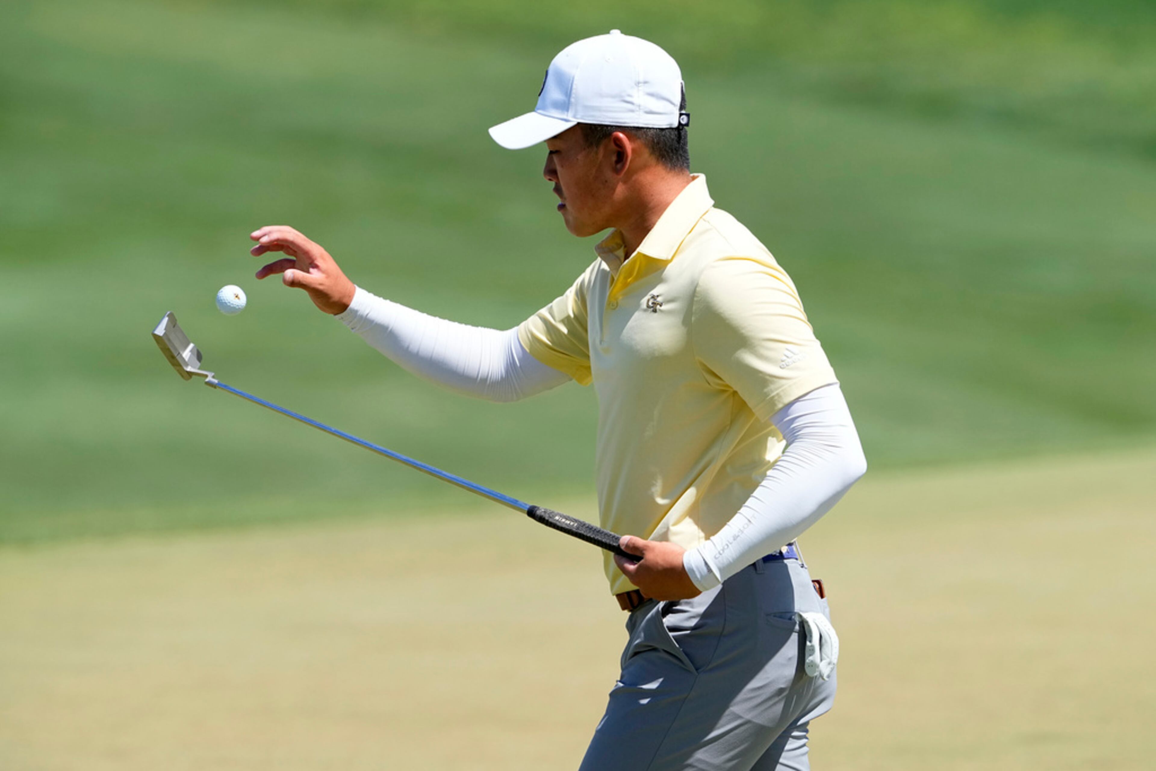 Georgia Tech golfer Hiroshi Tai flips up his ball from the second green during the final round of the NCAA college men's match play golf championship, Wednesday, May 31, 2023, in Scottsdale, Ariz. (AP Photo/Matt York)