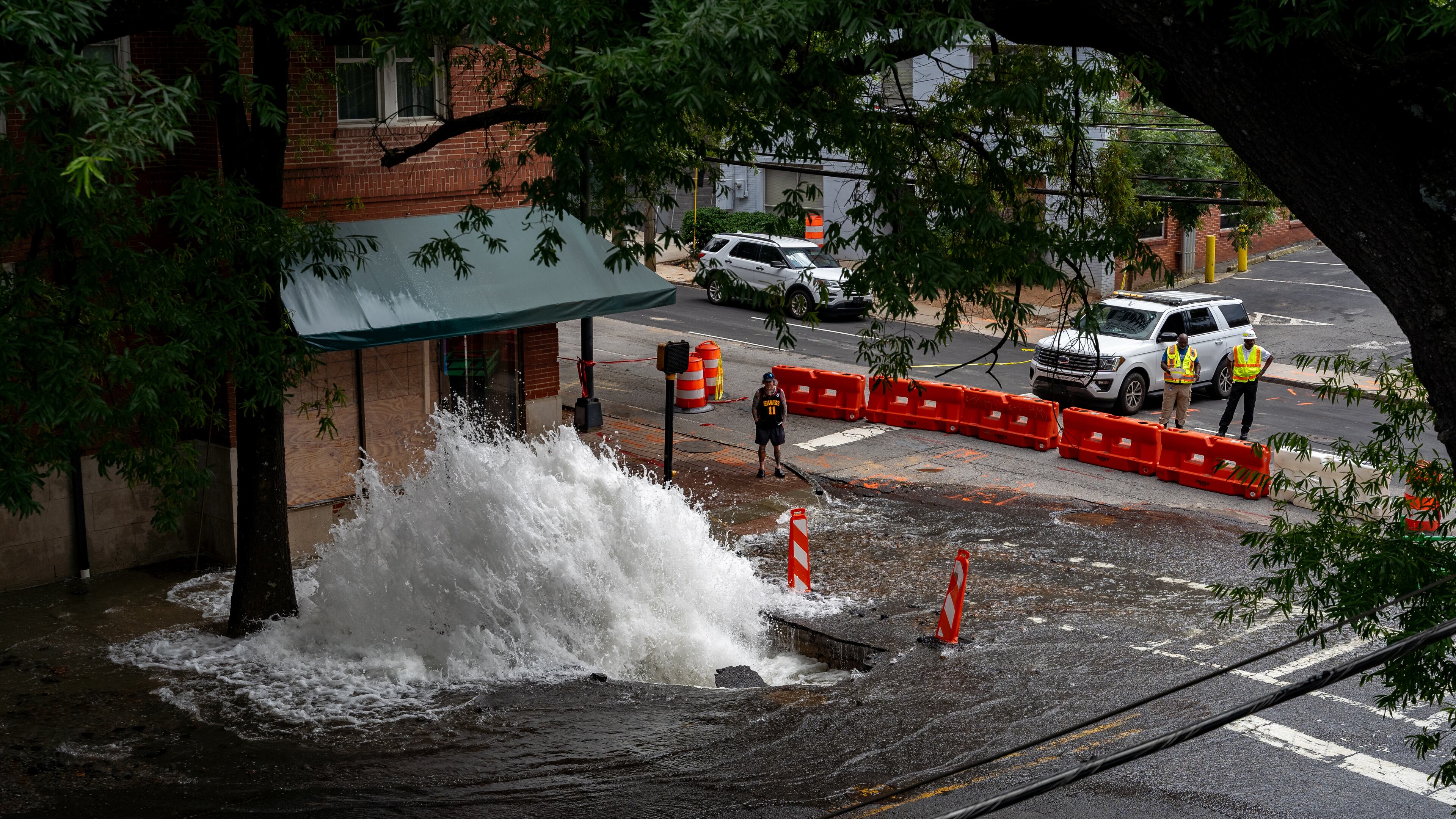 Water continued to flood out two days after a major water main broke near the intersection of 11th and West Peachtree streets in June. The geyser spewed for days after key shut-off valves in Midtown failed. Atlanta officials say the city wasn't doing enough to ensure the equipment would work in a crisis. Sunday, June 2nd, 2024 (Ben Hendren for the Atlanta Journal-Constitution)